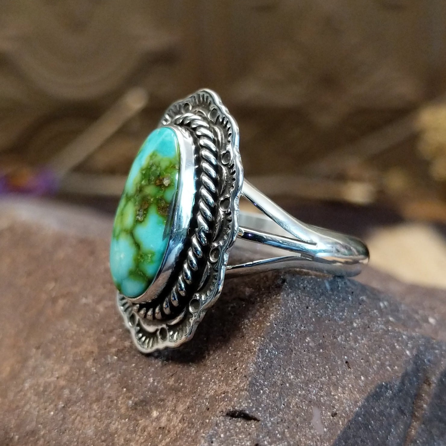 Sterling silver ring with Sonoran gold turquoise set in the oval bezel, framed by twisted rope and stamped setting.