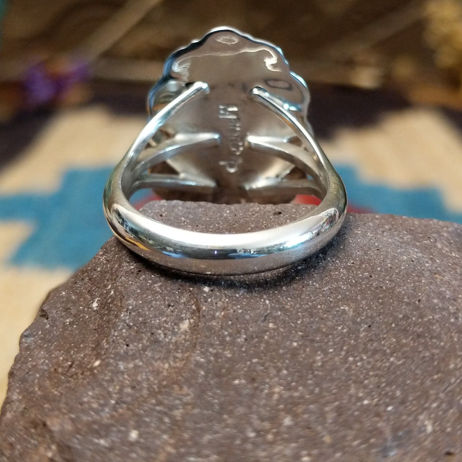 Sterling silver ring with Sonoran gold turquoise set in the oval bezel, framed by twisted rope and stamped setting.