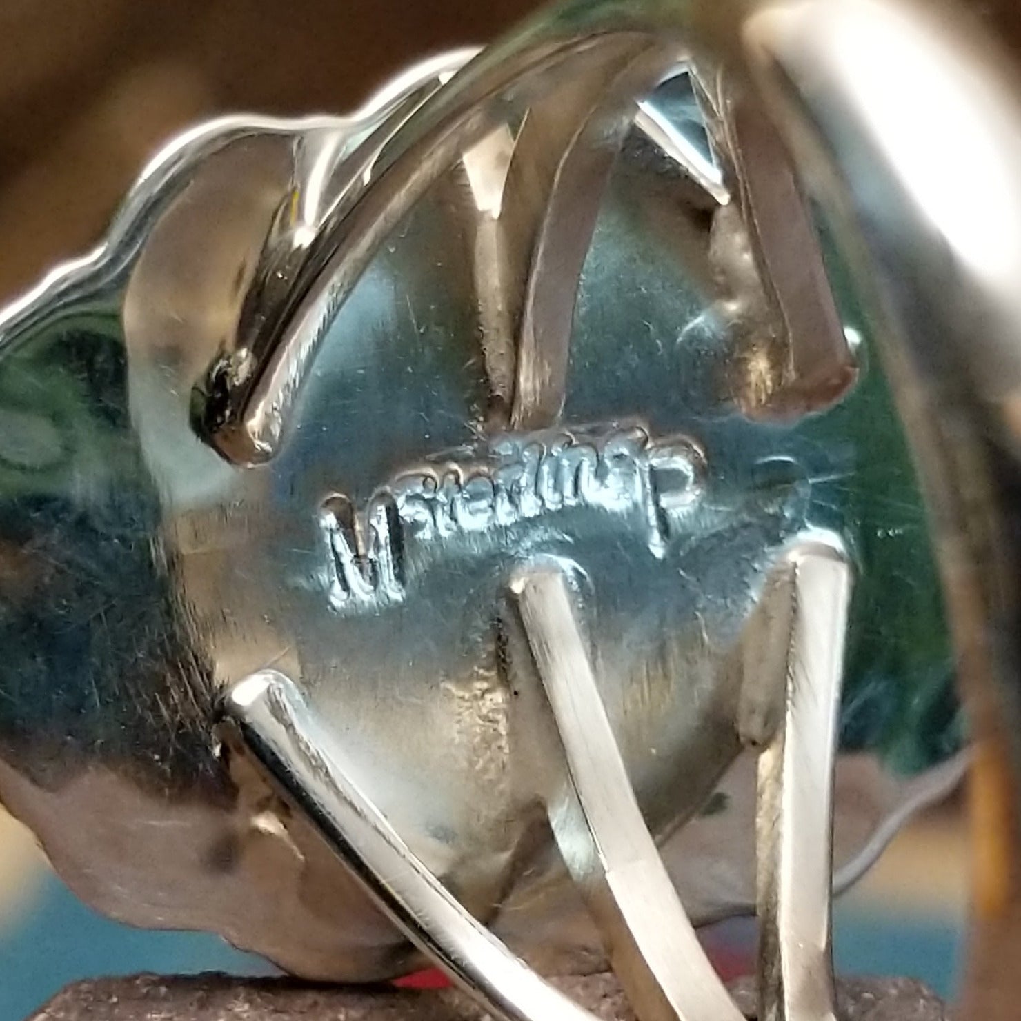 Close-up of the artisan's stamped signature.