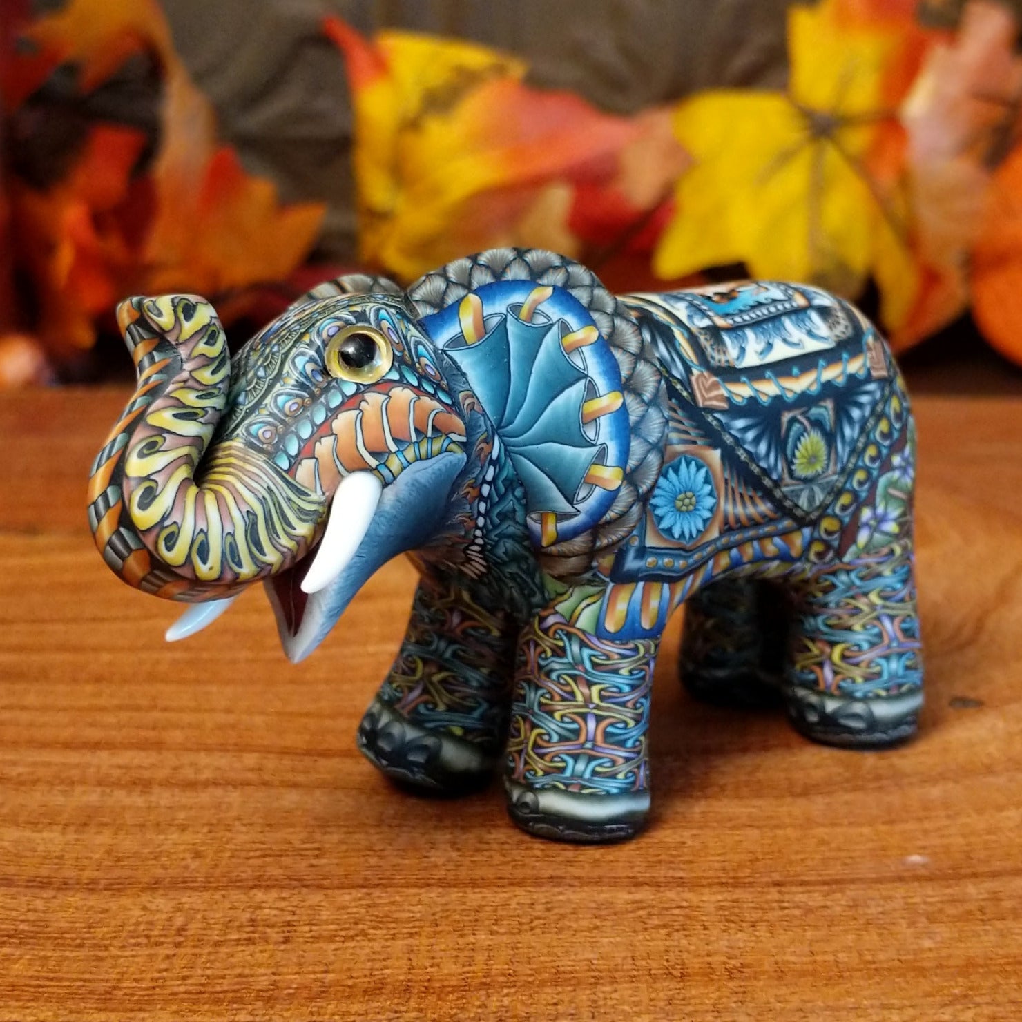 Polymer clay used to create an elephant with colorful geometric and floral designs.
