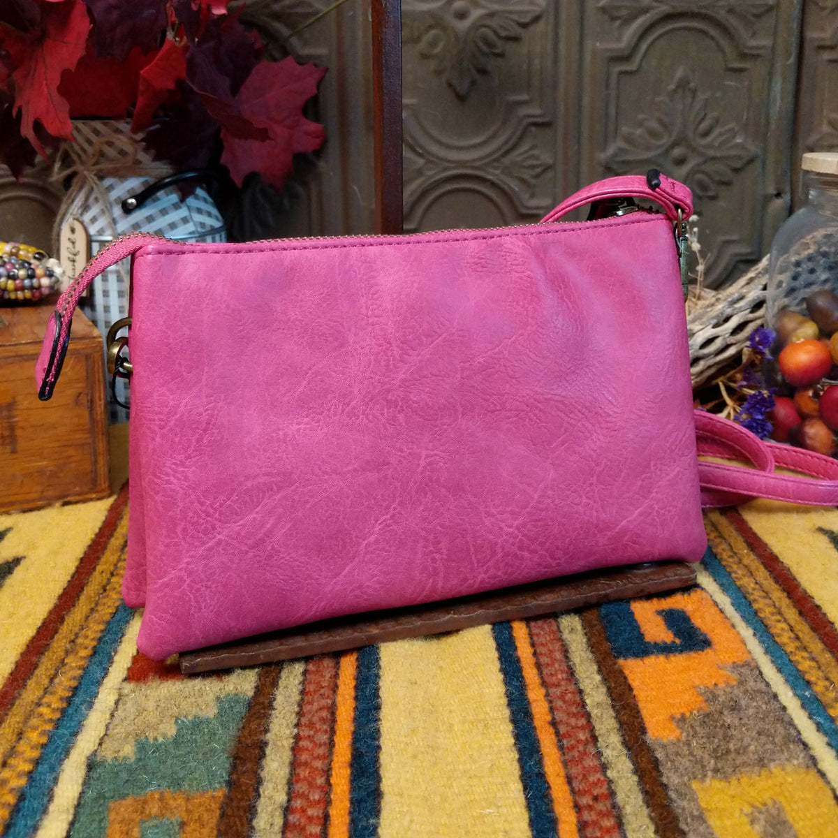 Ella Handbag by Liz Soto featuring a compact structured silhouette, textured exterior, dual handles, turn-lock accent, top zip closure, and rectangular Liz Soto logo plaque; back view.