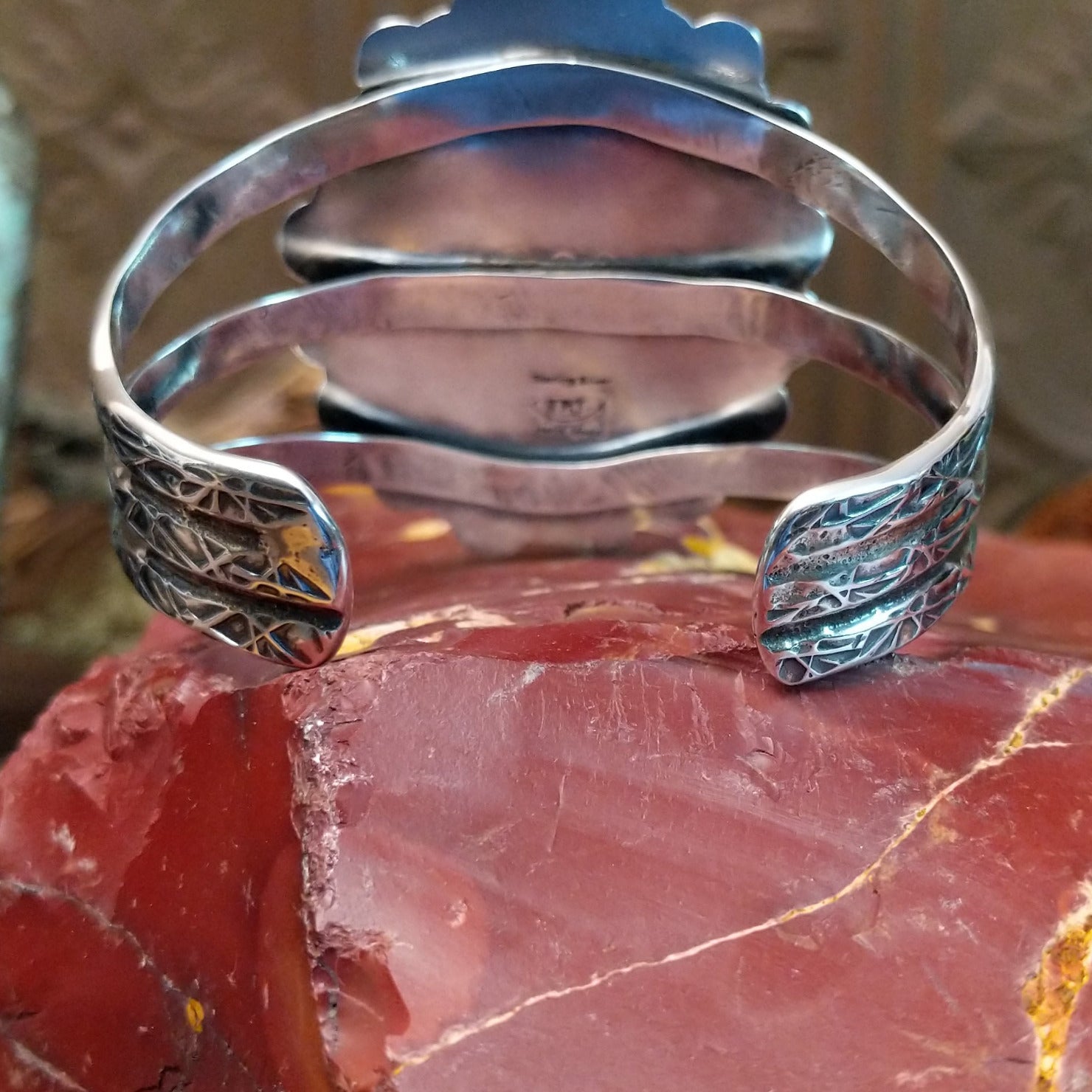 Sterling silver cuff bracelet with Kingman turquoise set in oval bezels, framed by twisted rope and dotted accents.
