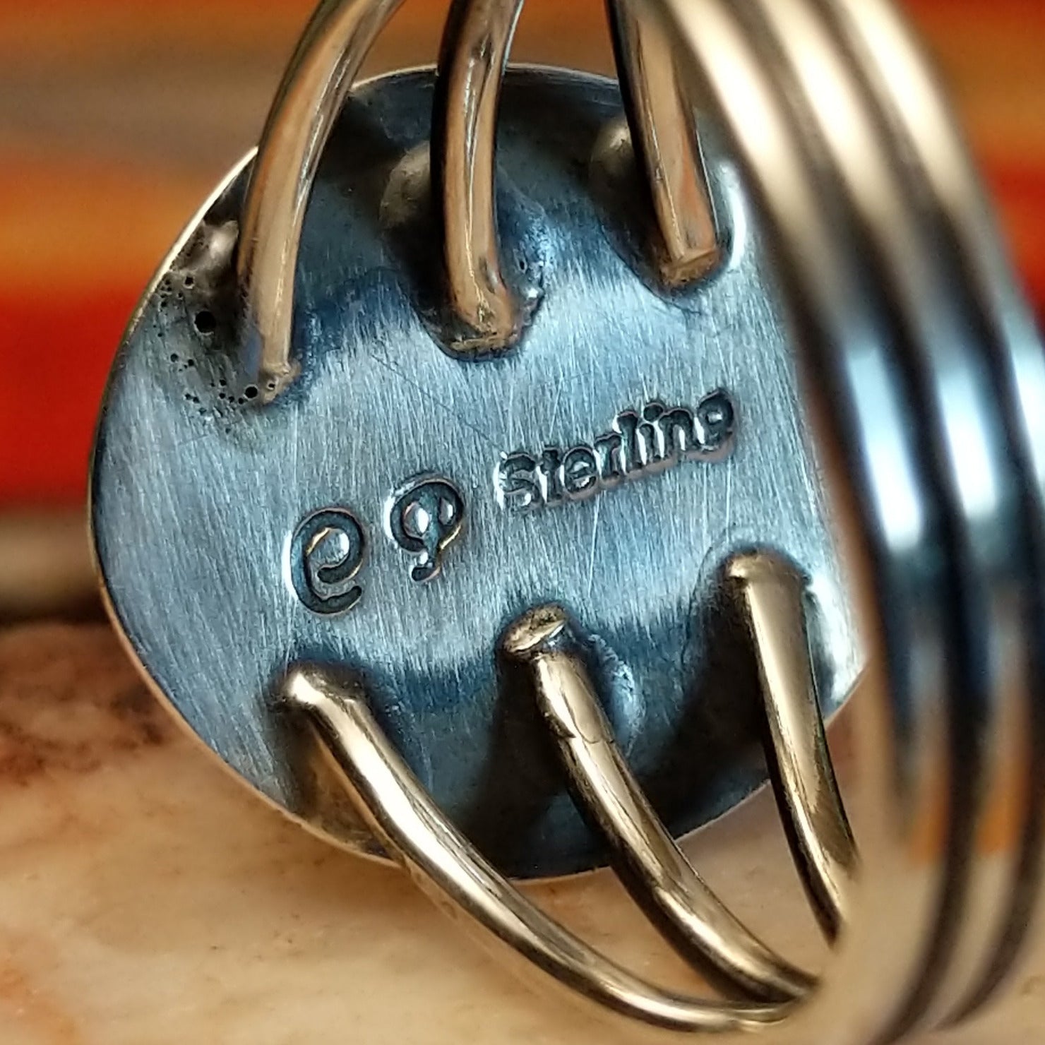 Close-up of the artisan's stamped signature.
