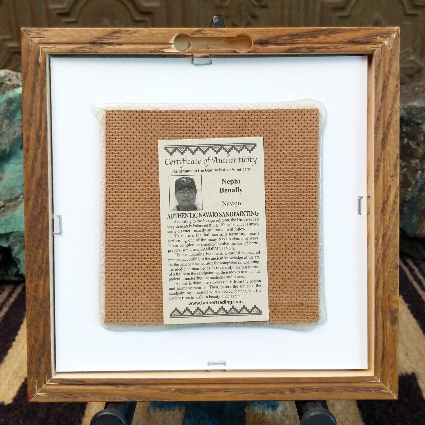 Backside of the Father Sky sand painting, showing the Certificate of Authenticity and Artist information.