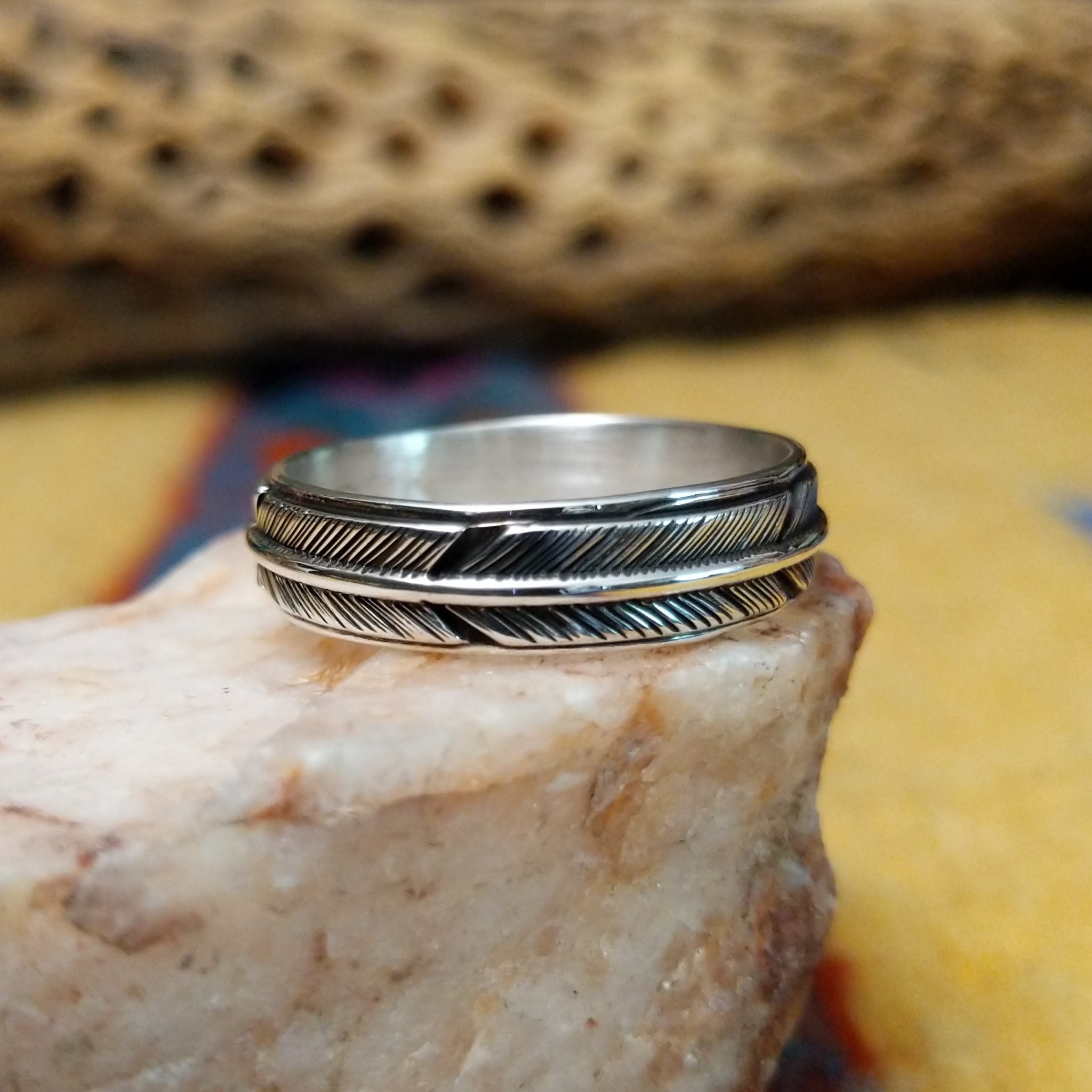 Feather loop ring by Raymond Coriz, featuring a detailed handcrafted feather design wrapped around a polished sterling silver band with traditional Southwestern-inspired craftsmanship.