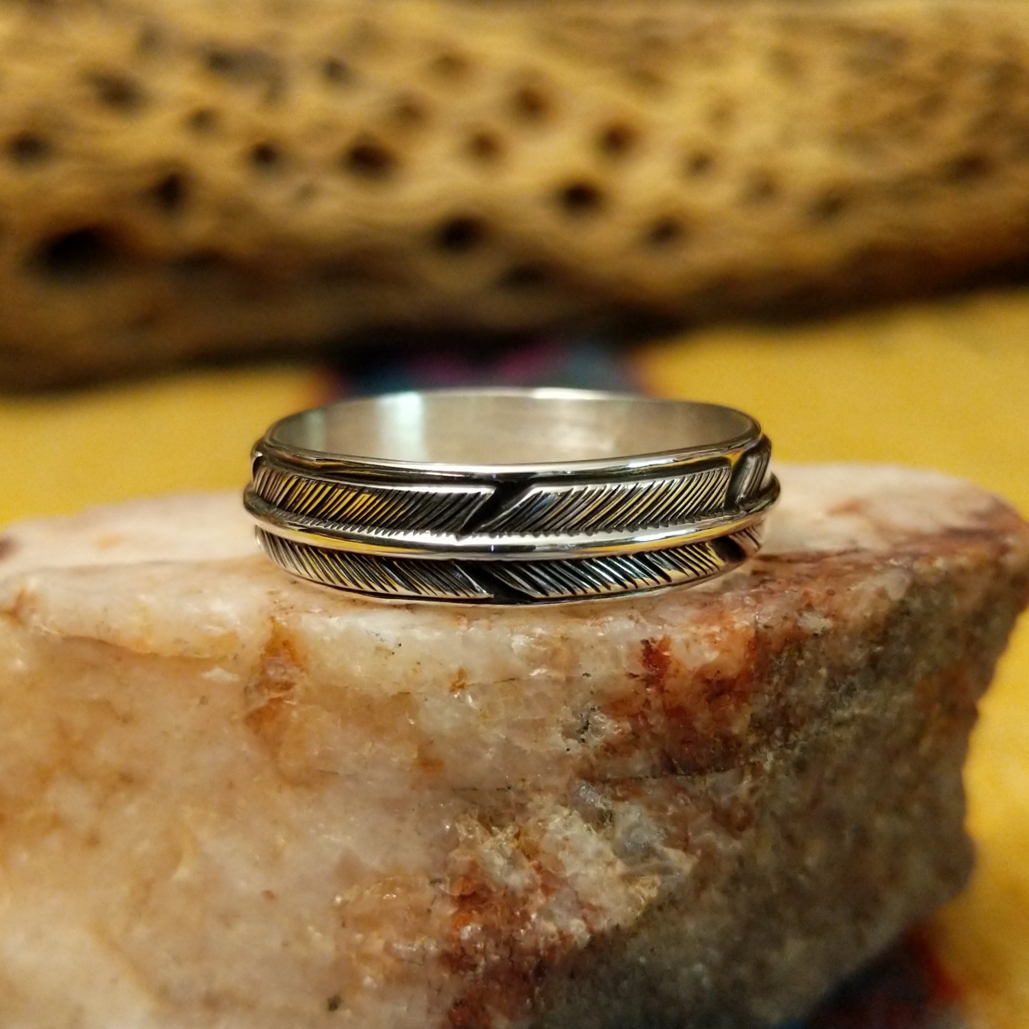 Feather loop ring by Raymond Coriz, featuring a detailed handcrafted feather design wrapped around a polished sterling silver band with traditional Southwestern-inspired craftsmanship.