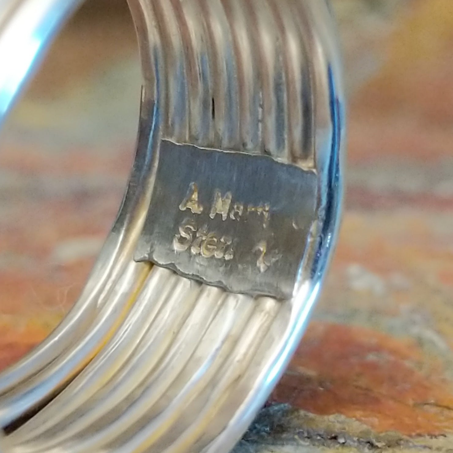 Close-up of the artisan's stamped signature.