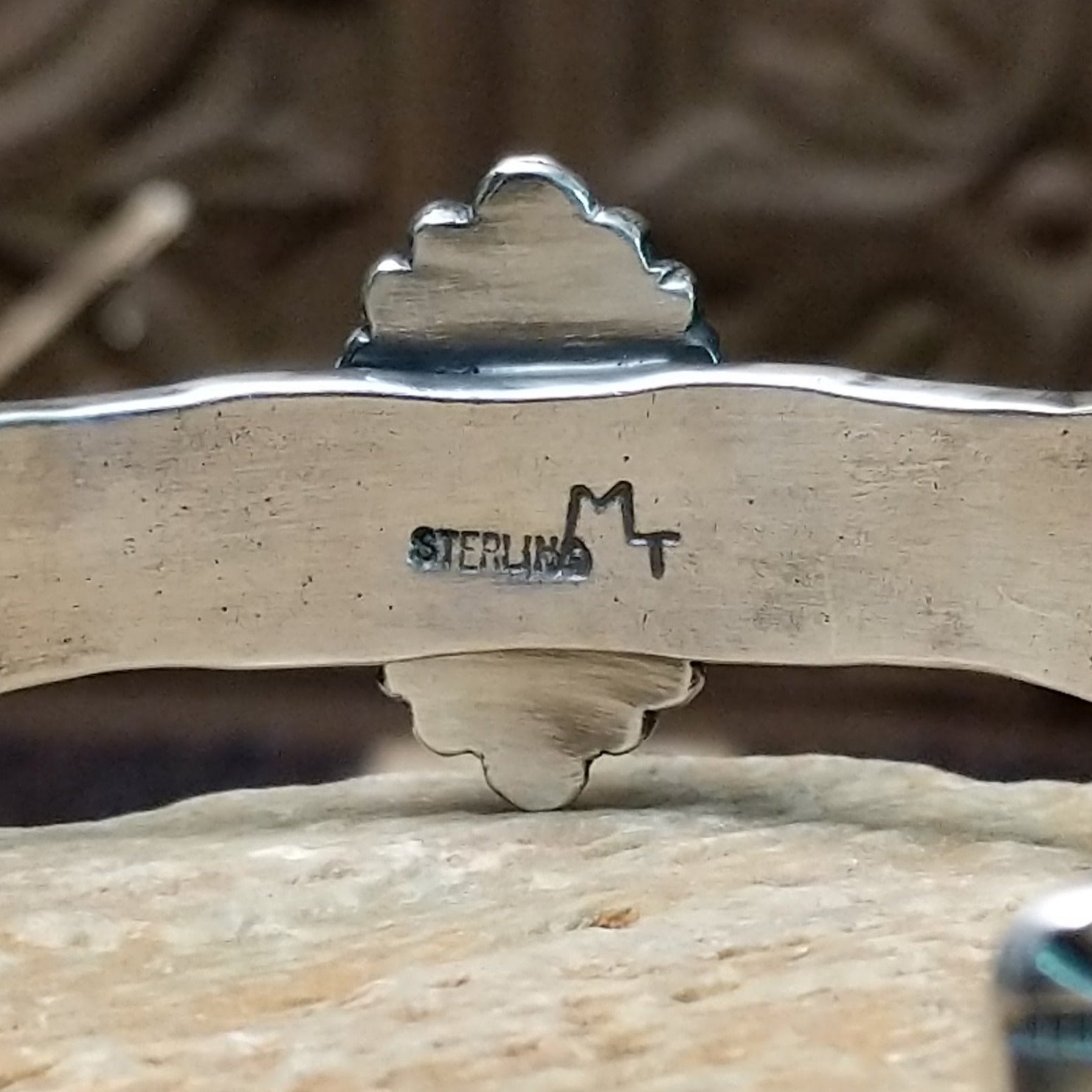 Close-up of the artisan's stamped signature.
