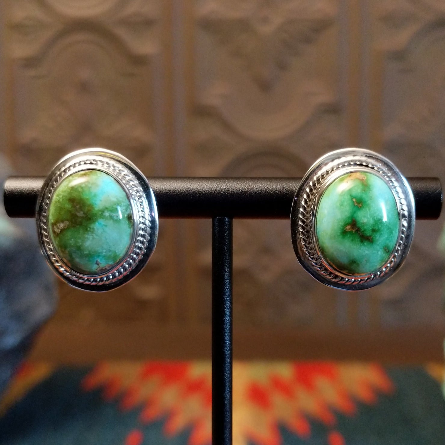 Sterling silver earrings with sonoran gold turquoise set in the bezels, framed by precise silverwork lines.