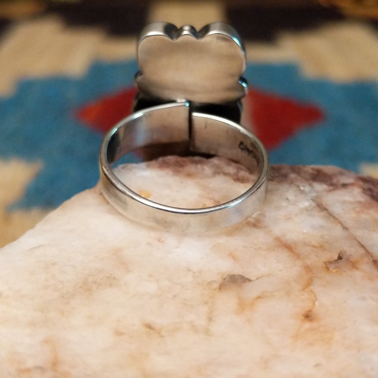 Sterling silver ring with freshwater pearl set in six bezels, framed by dotted accents.