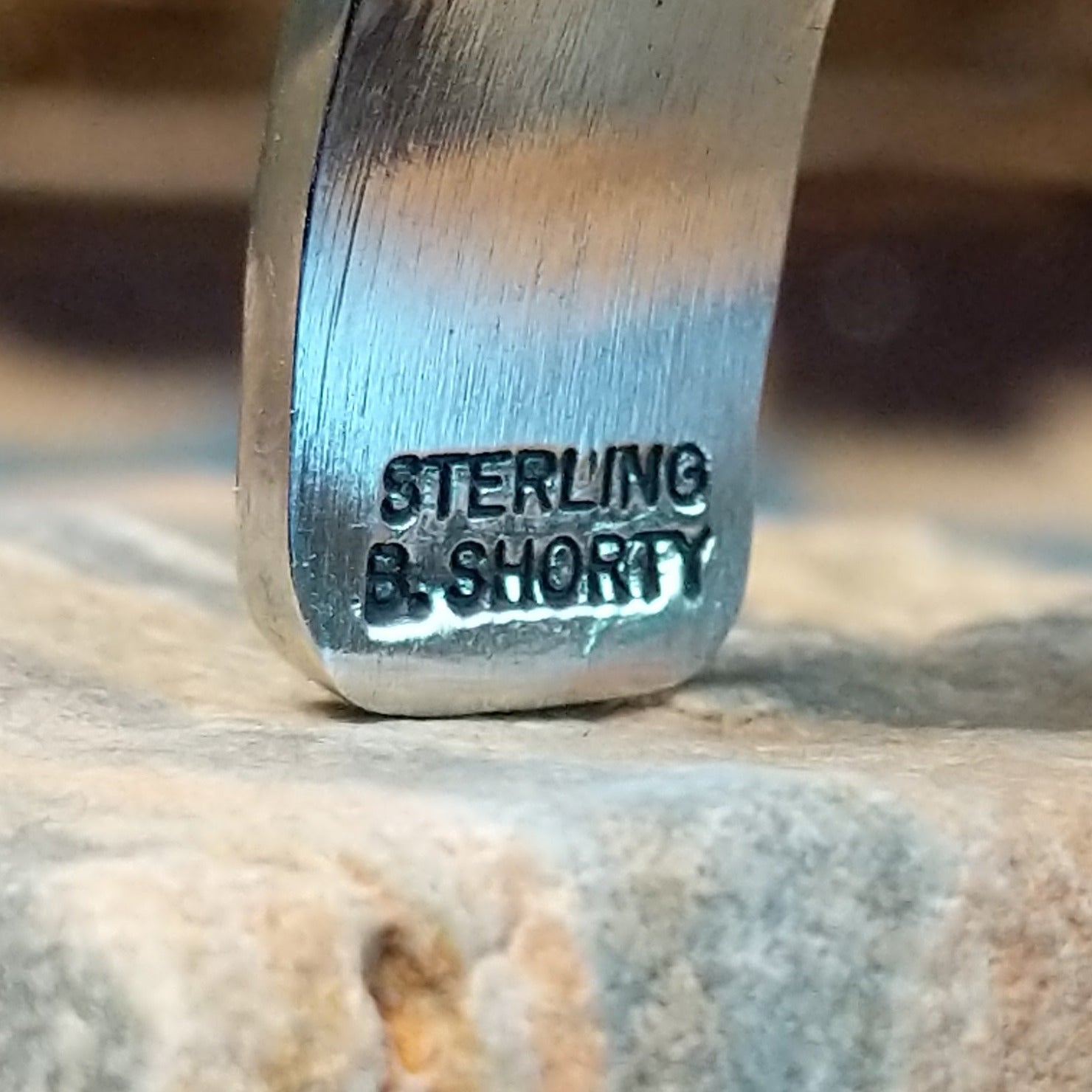 Close-up of the artisan's stamped signature.