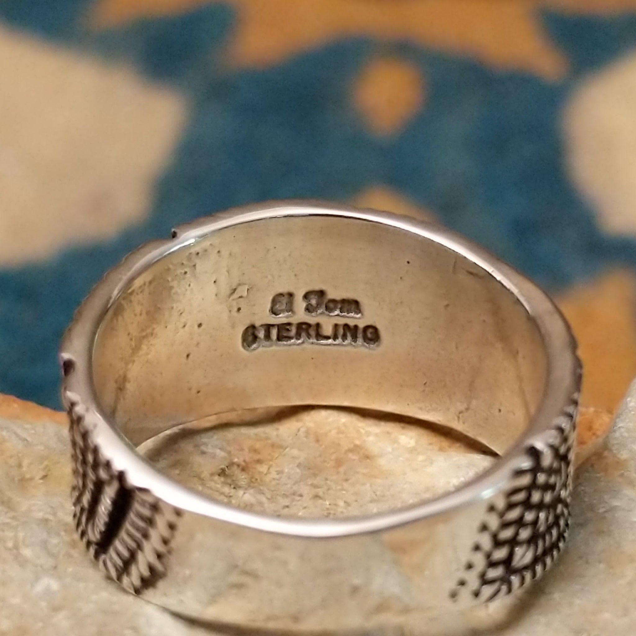 Sterling silver geometric band ring by Elgin Tom with hand-stamped spiral patterns; artisan and Sterling Silver stamp.
