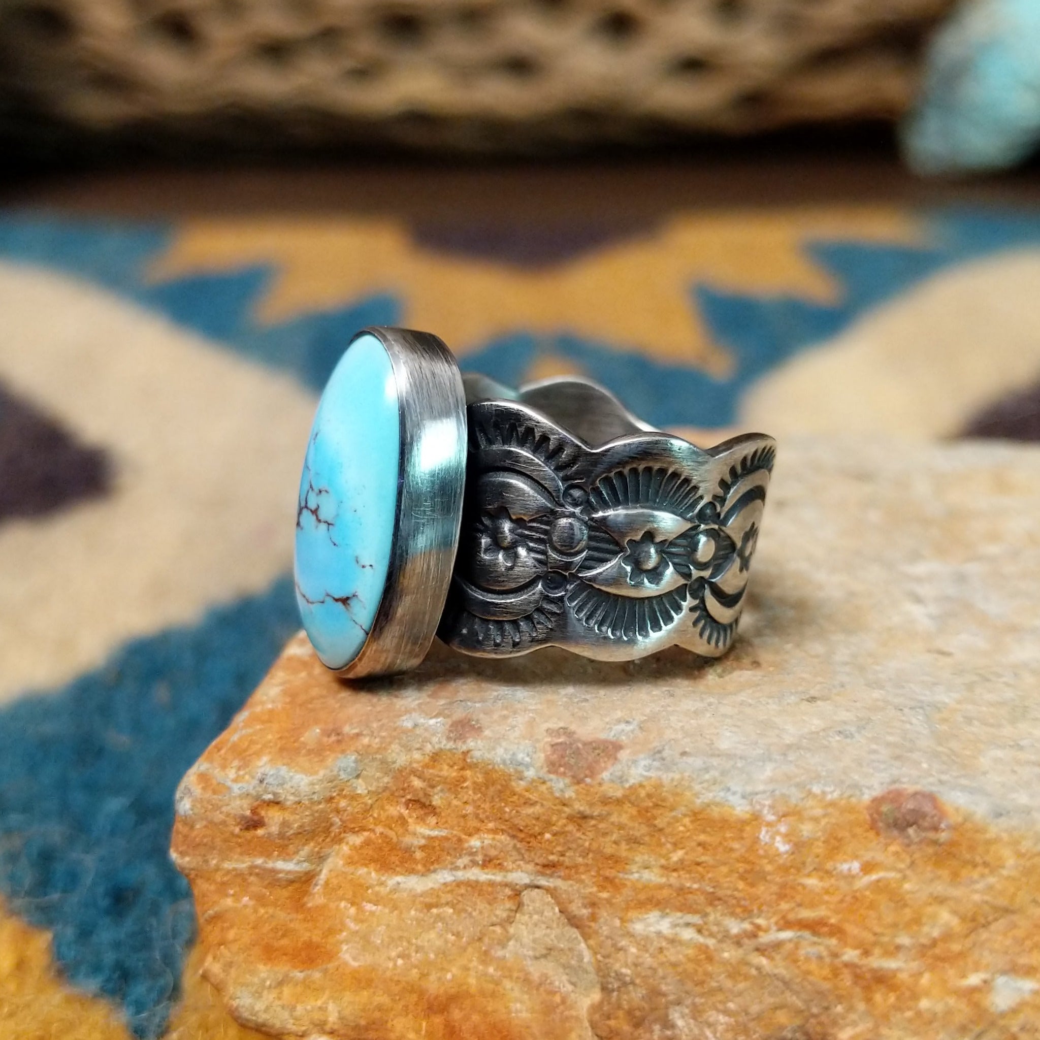 Handcrafted sterling silver Golden Hills turquoise ovoid ring by Leonard Maloney, featuring a natural sky-blue Golden Hills turquoise gemstone with lavender-gray matrix; side view.