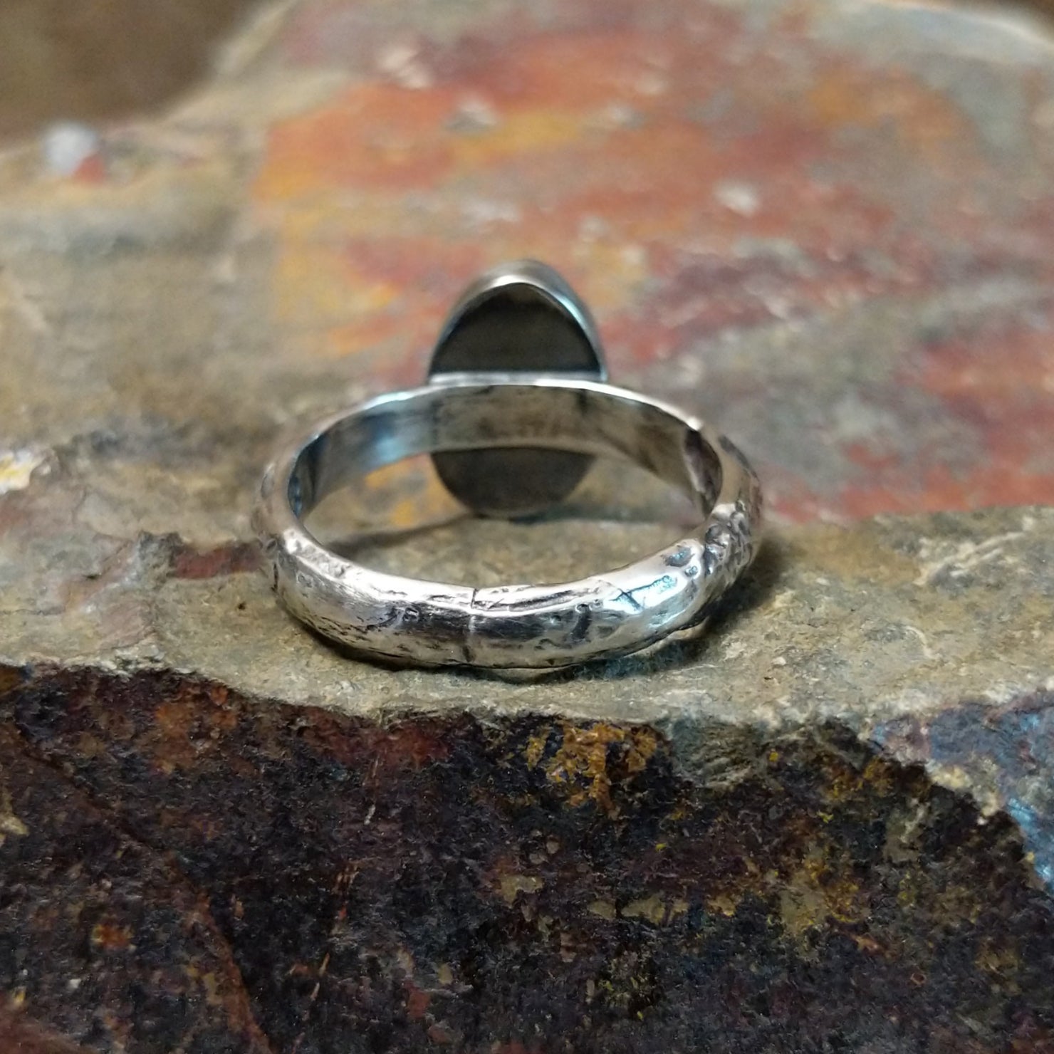The ring’s band features a textured silver finish.