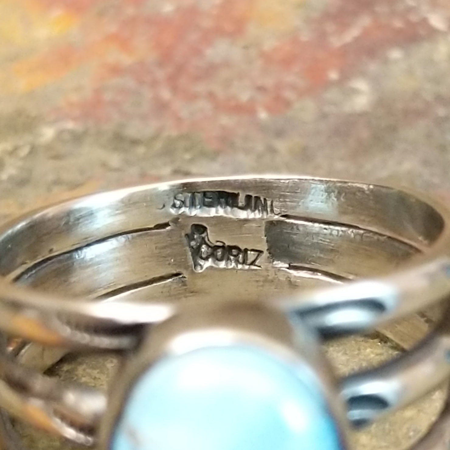 A clear brand signature is etched into the silver.