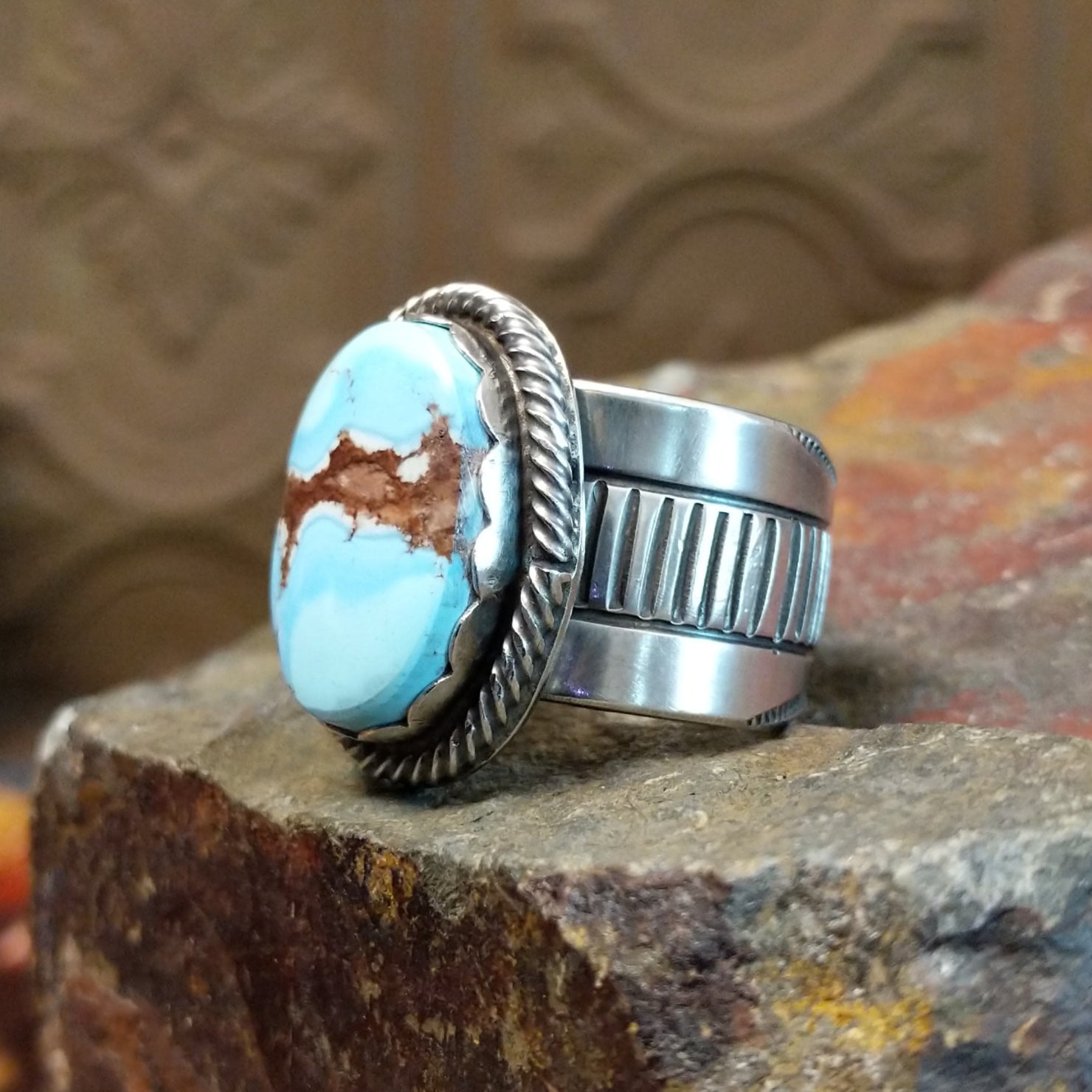 The band design showcases polished silver with ribbed detailing.