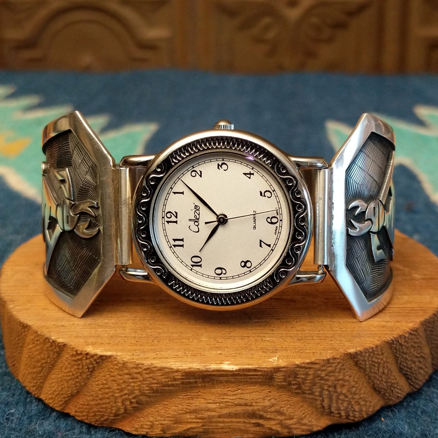 Sterling silver and stainless steel watch with ornate detailing on the bezel and flute players on the bracelet.