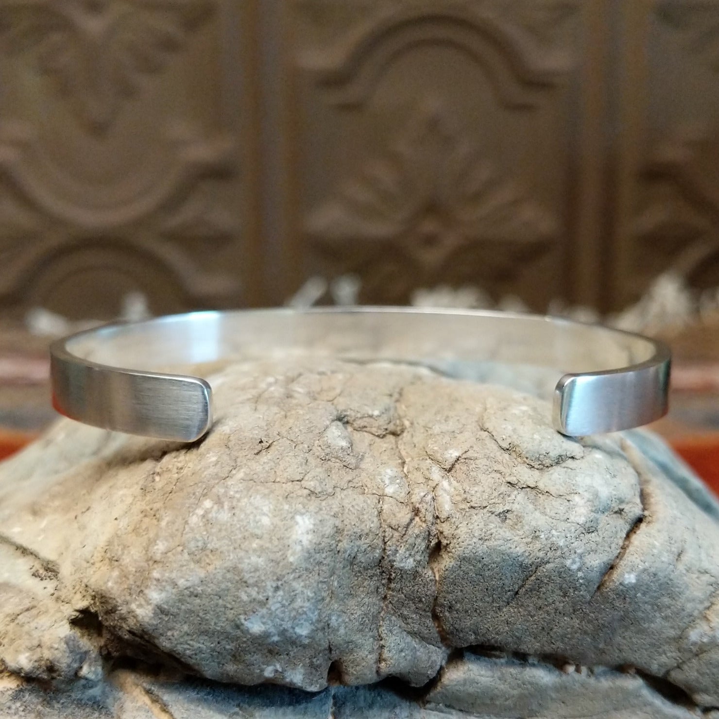The cuff is brushed silver.