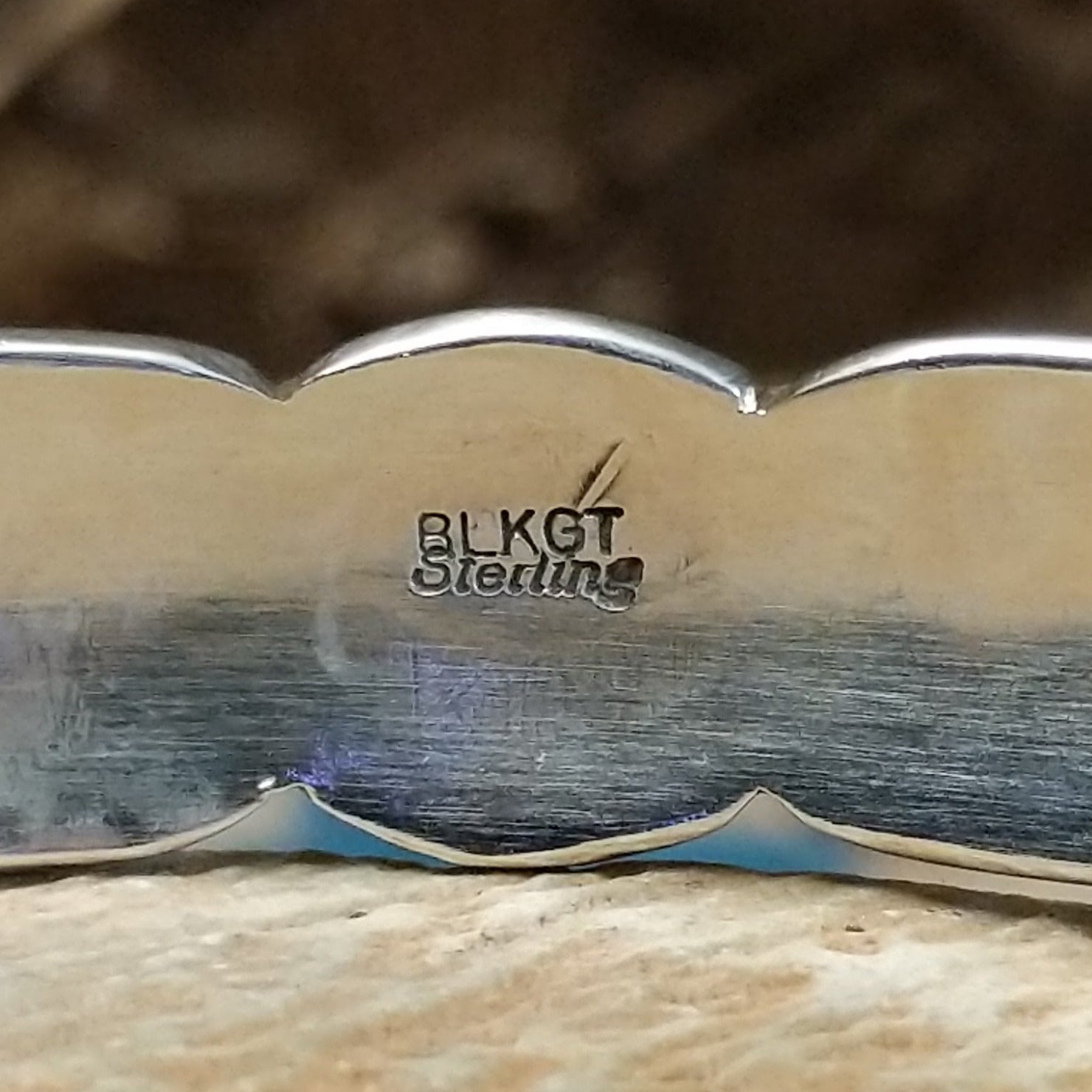 Close-up of the artisan's stamped signature.