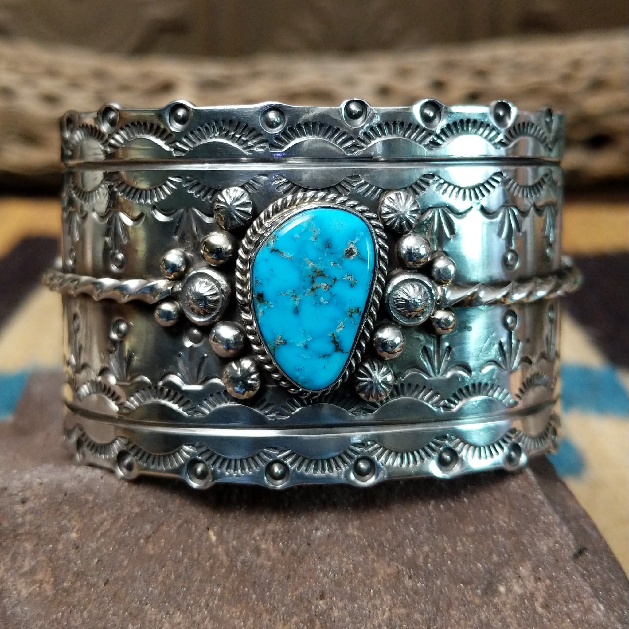 Kingman turquoise cuff by Betty A. Lee featuring a natural blue turquoise stone on a wide hand-stamped sterling silver cuff.