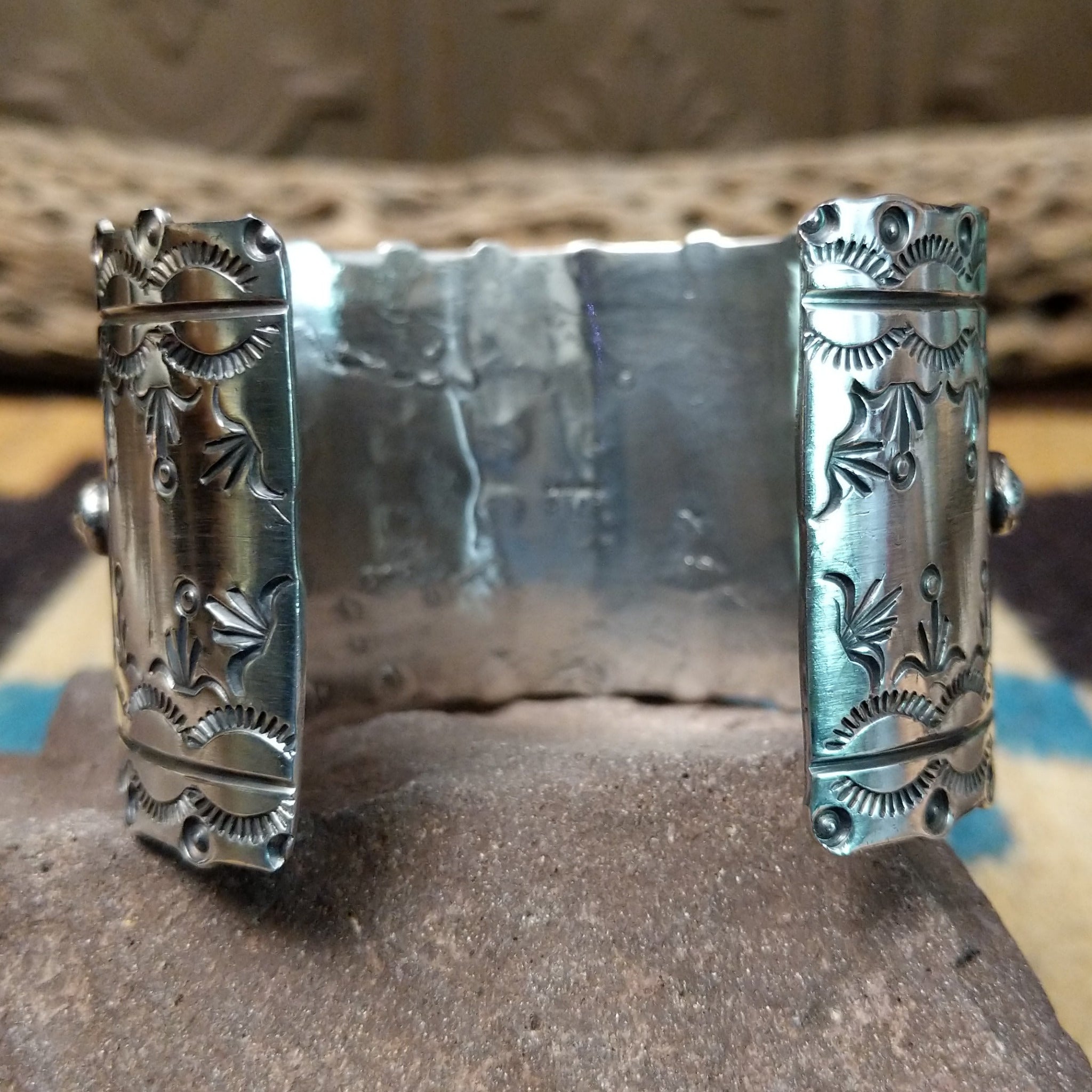 Kingman turquoise cuff by Betty A. Lee featuring a natural blue turquoise stone on a wide hand-stamped sterling silver cuff; underside view.
