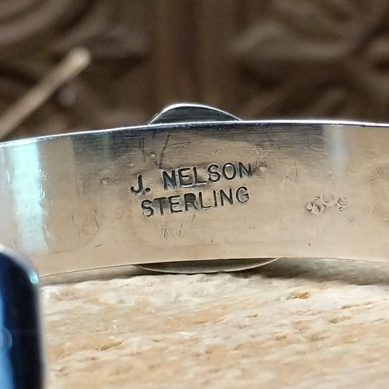 Close-up of the artisan's stamped signature.