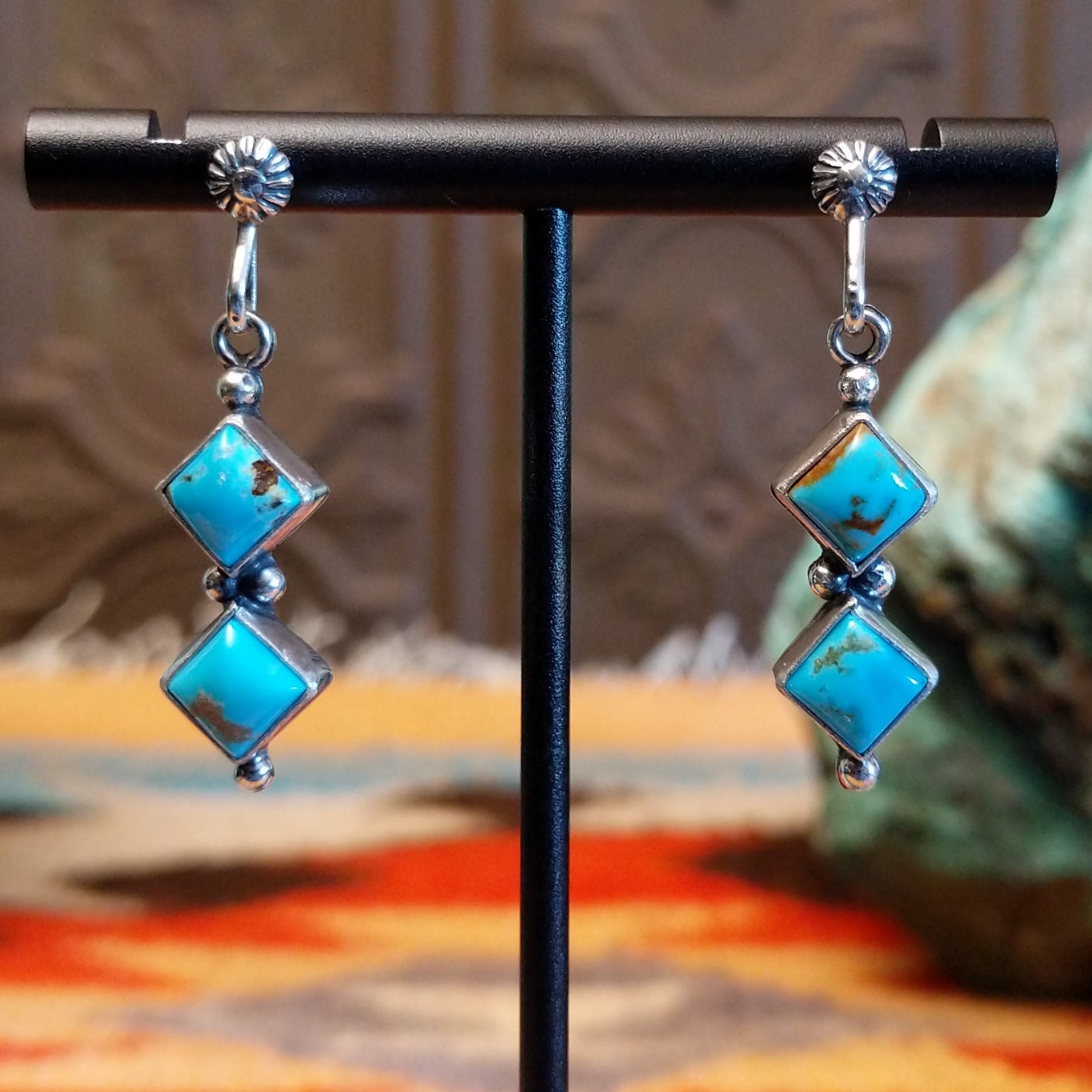 Sterling silver dangle earrings with Kingman turquoise set in the diamond-shaped bezels.
