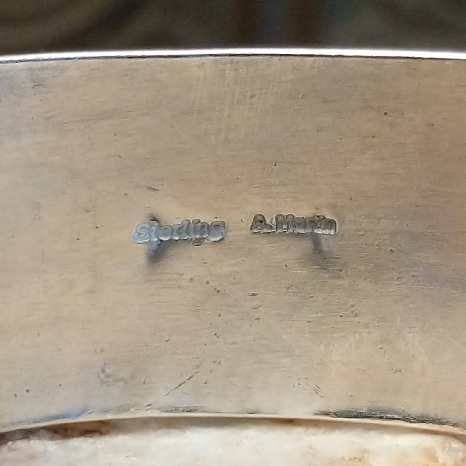 Close-up of the artisan's stamped signature.