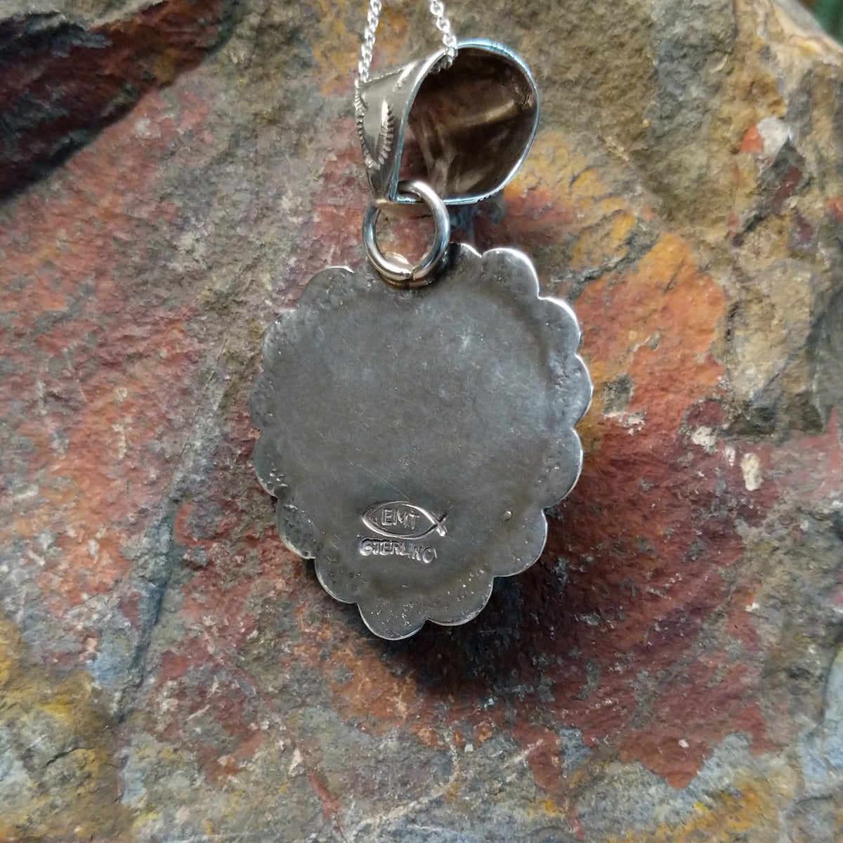 with golden-brown matrix surrounded by ornate sterling silverwork; artisan and Sterling Silver stamp.