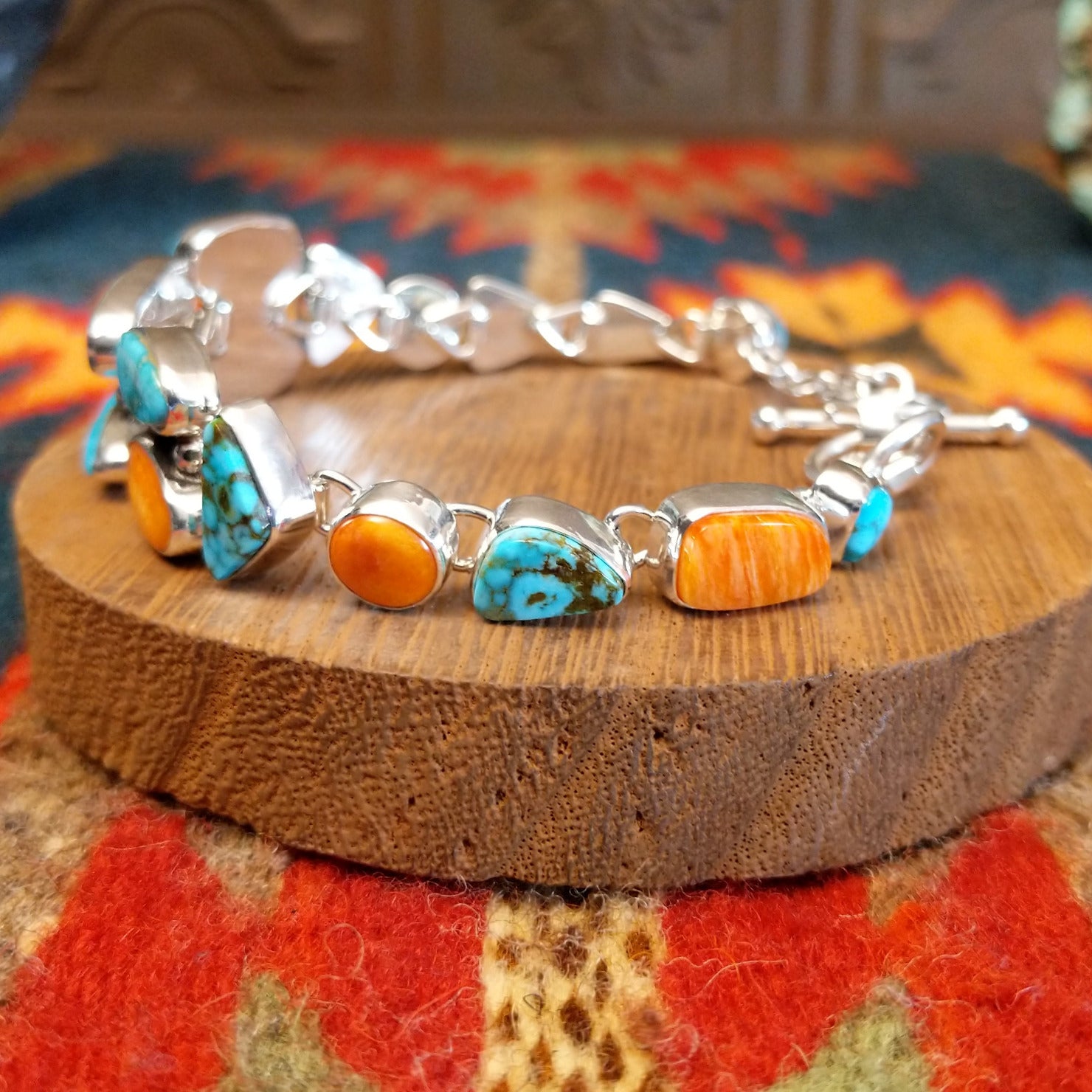 Sterling silver bracelet with Kingman turquoise and orange spiny oyster shell set in geometric bezels that make up the band.