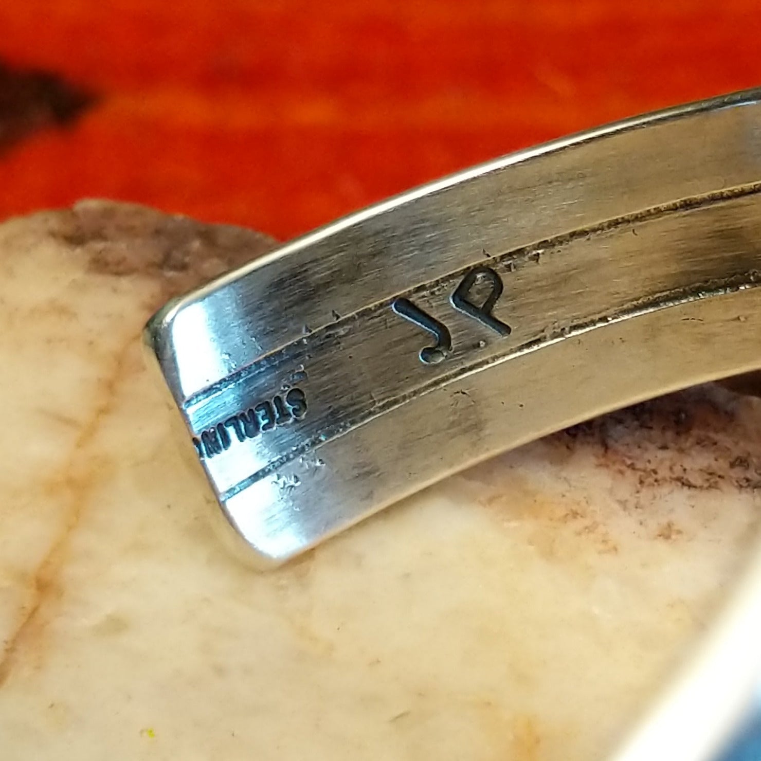 Close-up of the artisan's stamped signature.