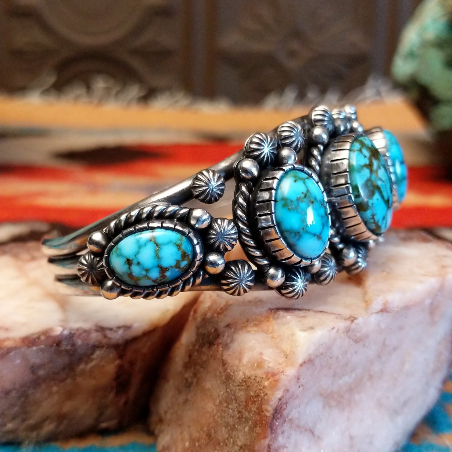 Sterling silver pentad cuff with Kingman turquoise set in round bezels, framed by twisted rope, star, and dotted accents.