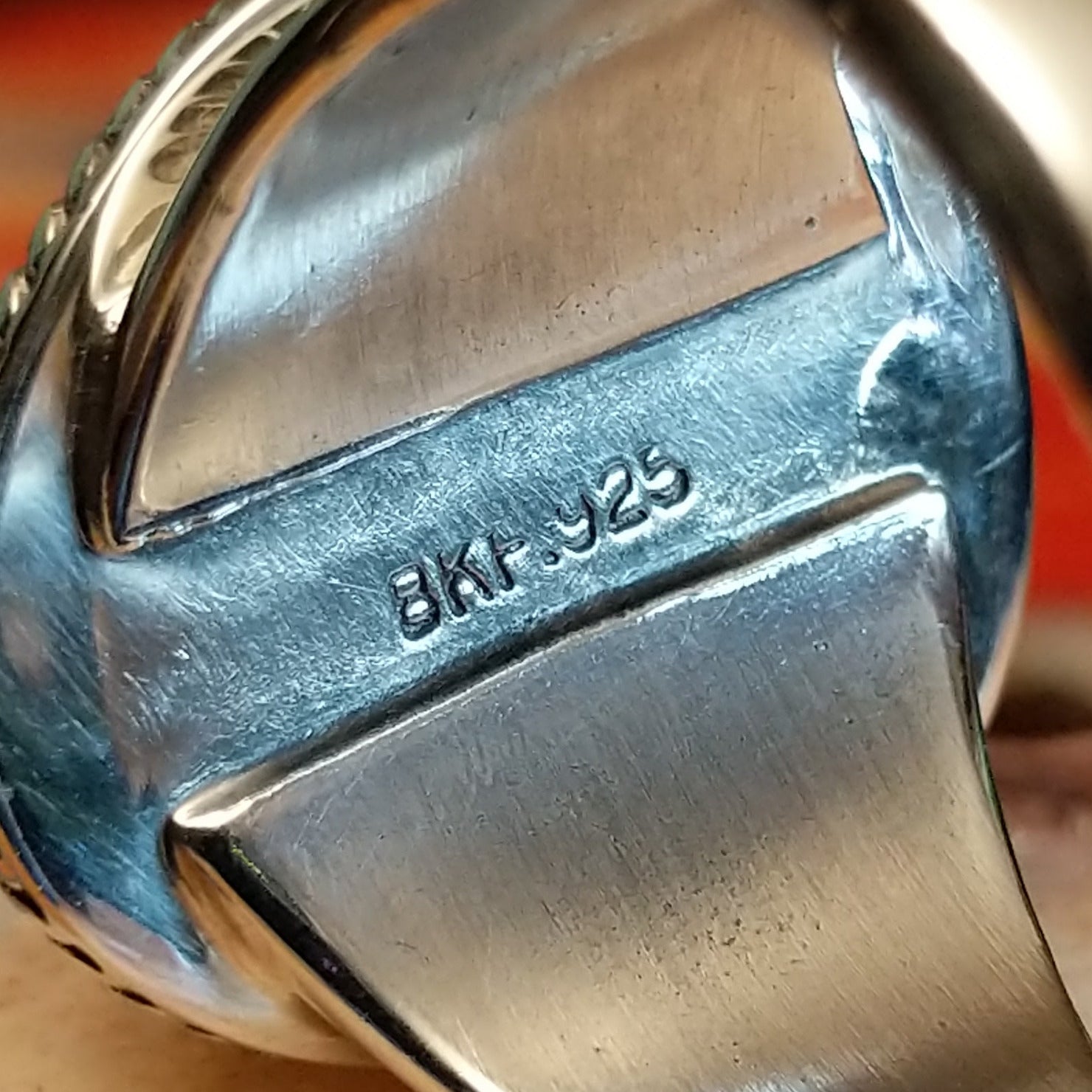 Close-up of the artisan's stamped signature.