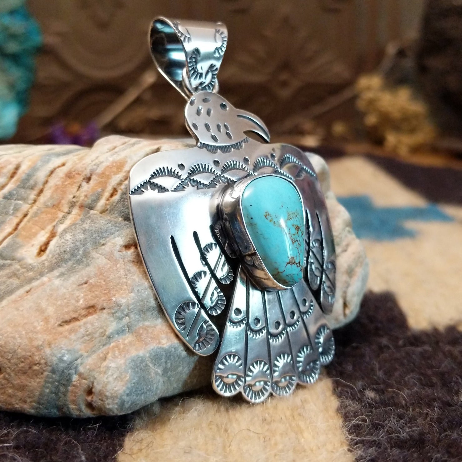 Sterling silver thunderbird pendant with Kingman turquoise set in a bezel.