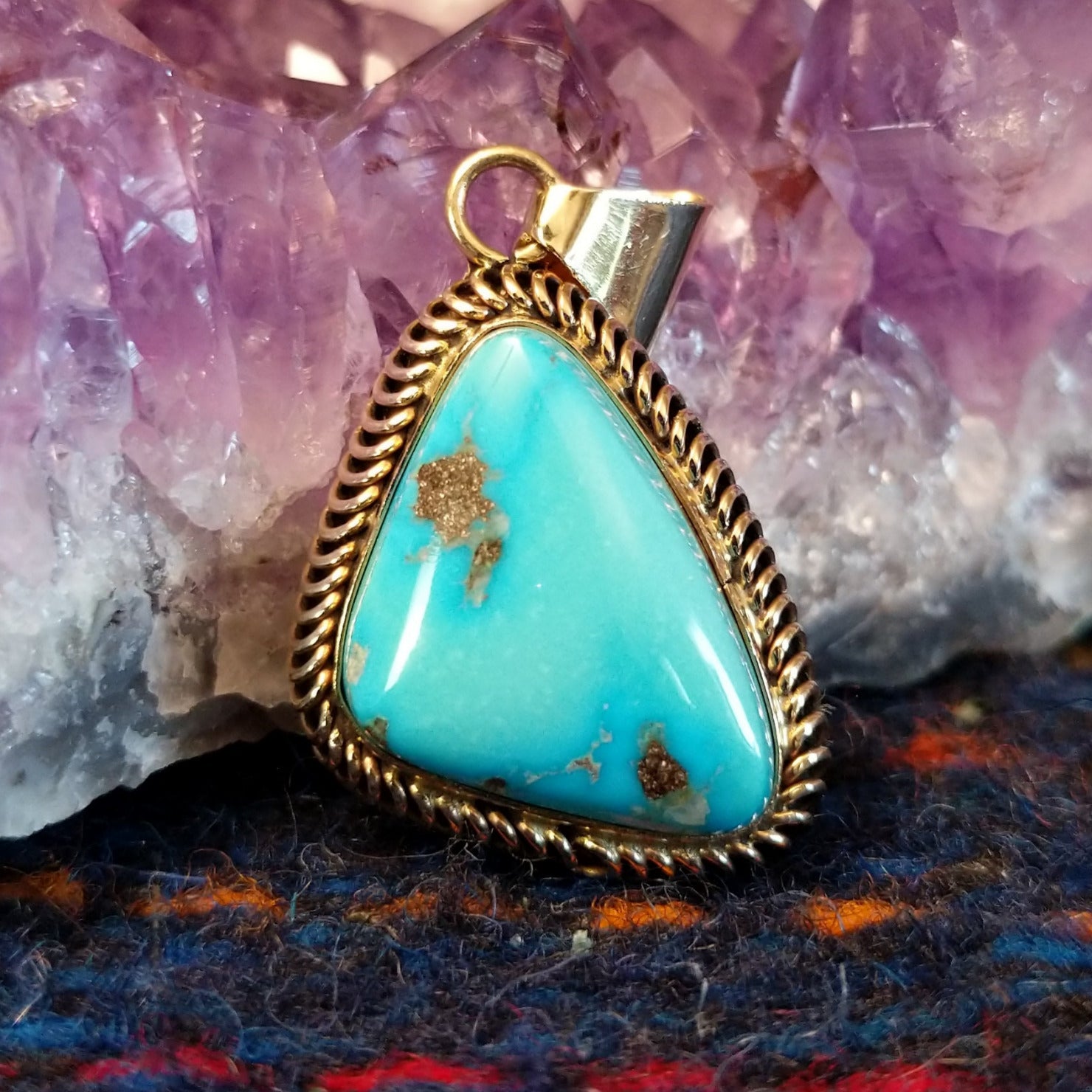 Kingman turquoise triangular gold pendant with a gold coil bezel.