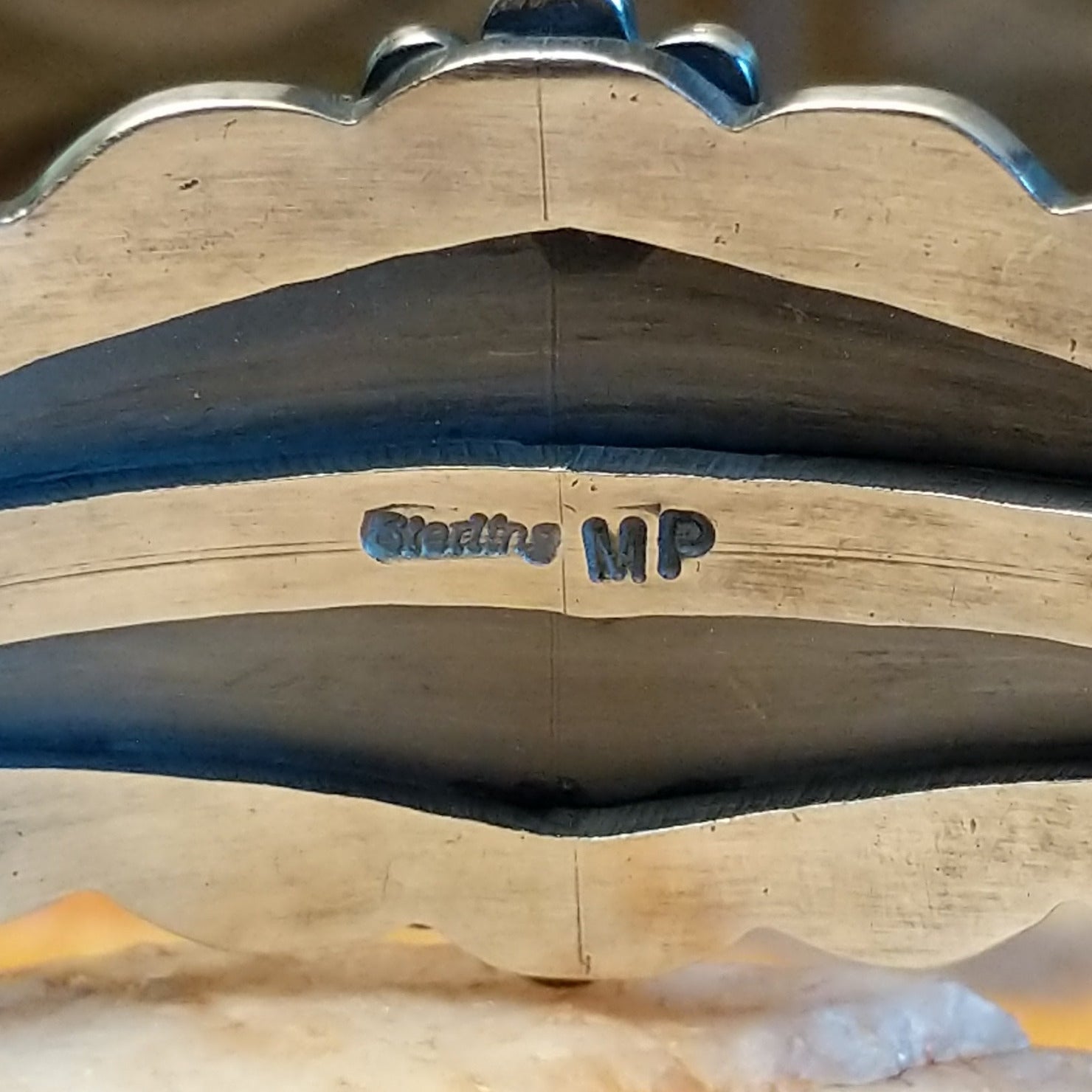 Close-up of the artisan's stamped signature.