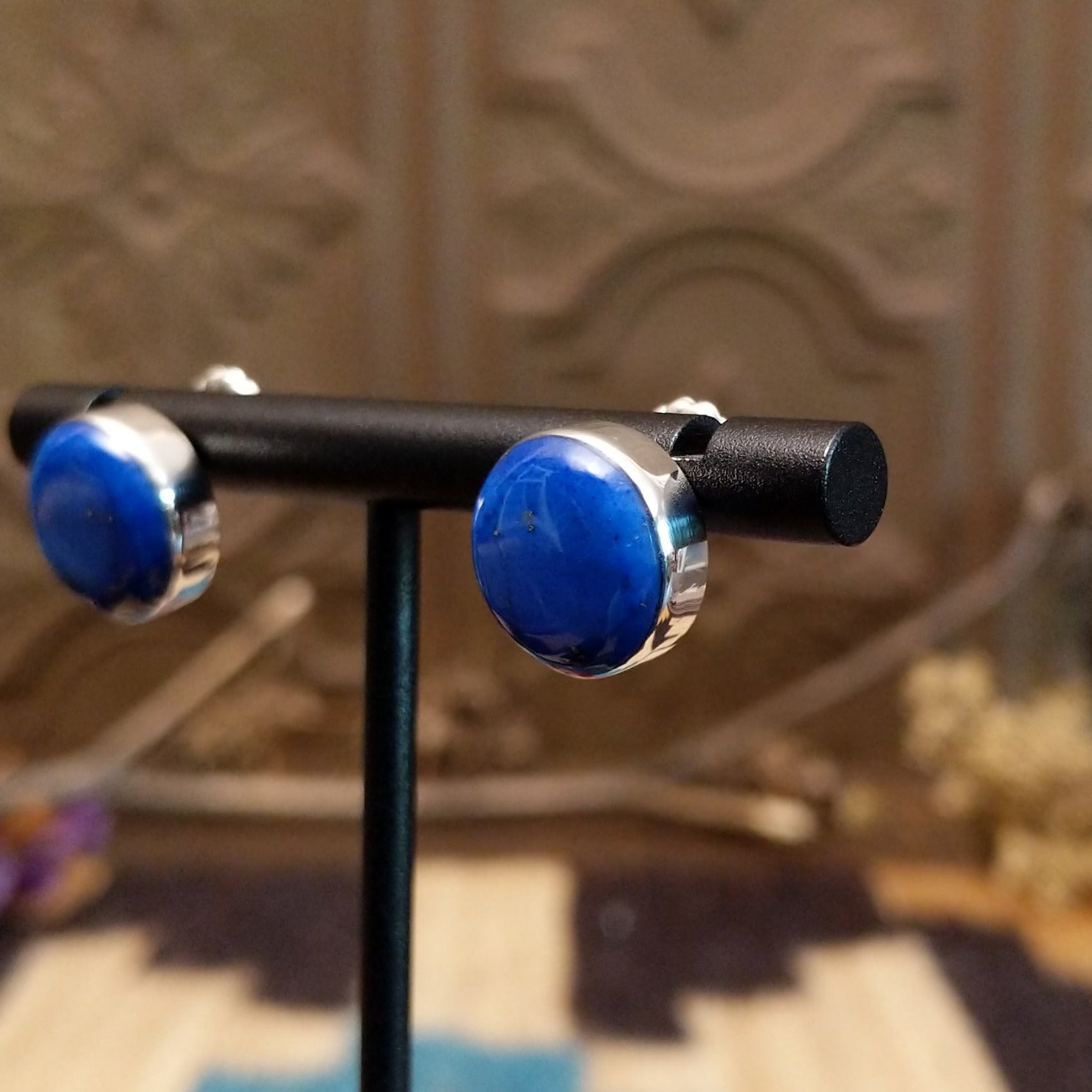 Sterling silver earrings with lapis set in round bezels.