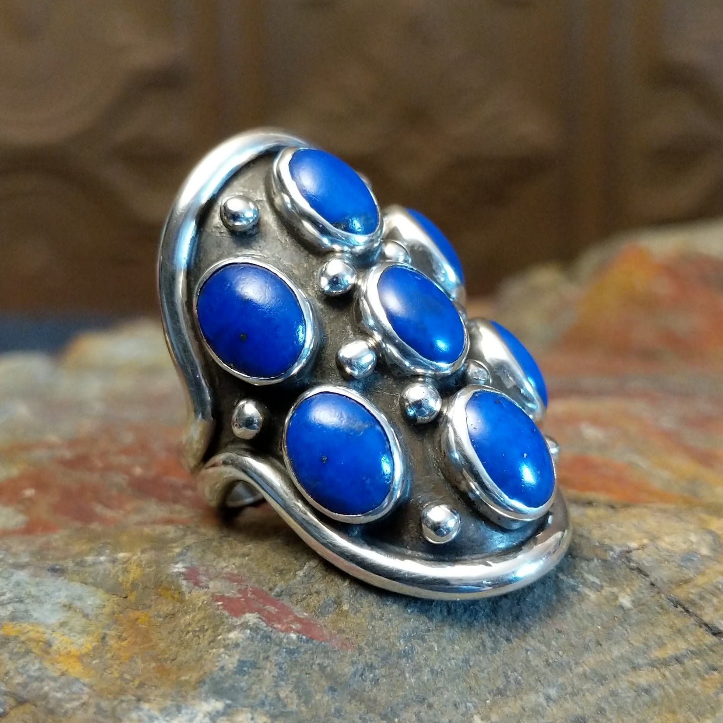 Sterling silver ring with lapis set in clustered bezels.