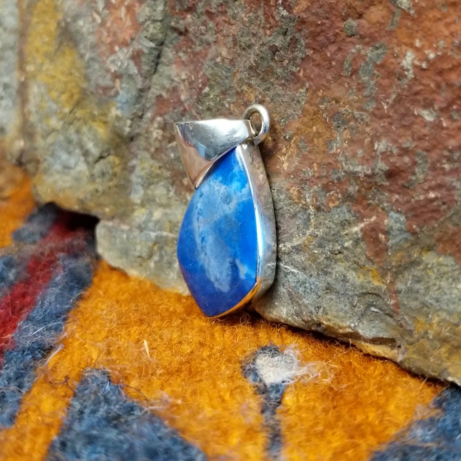 Sterling silver deltoid pendant with turquoise set in the bezel.