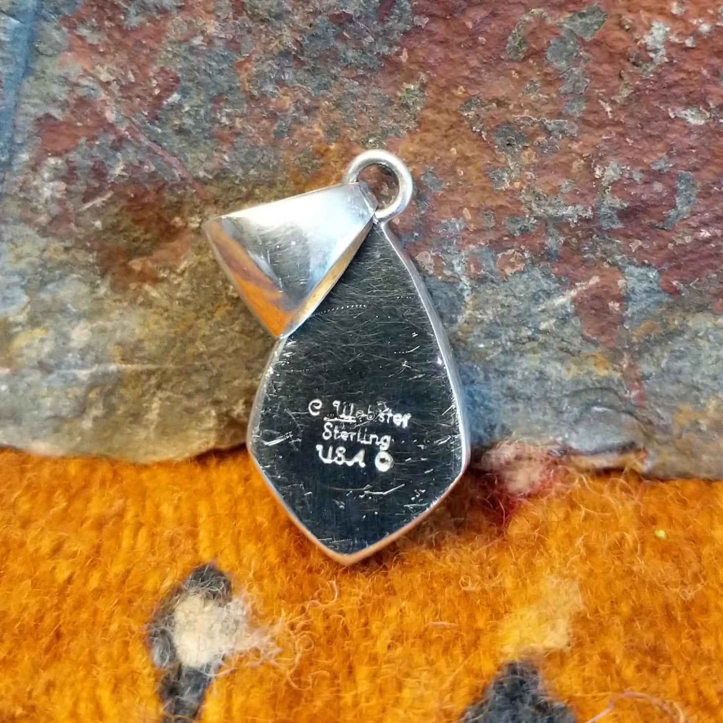 Close-up of the artisan's stamped signature.