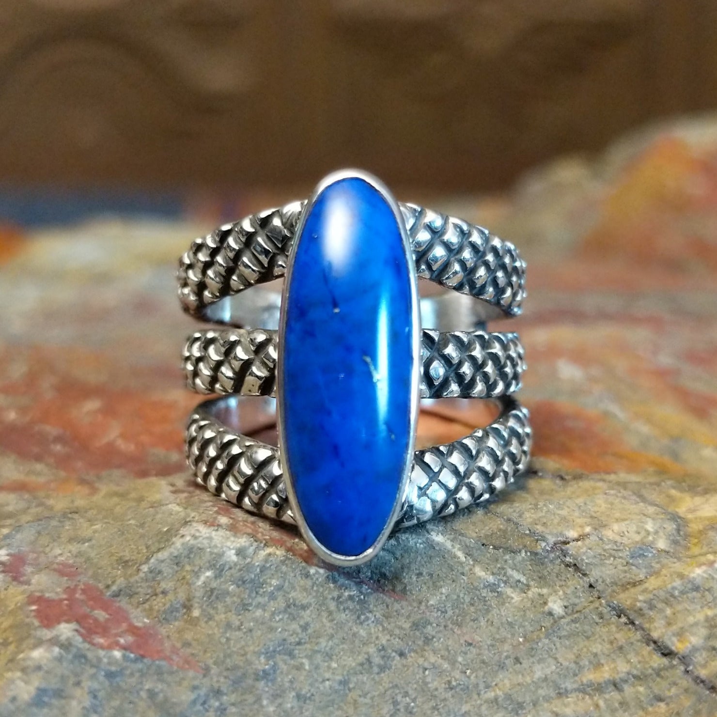 Sterling silver ring with lapis set in the bezel and tri-layered knurled band.