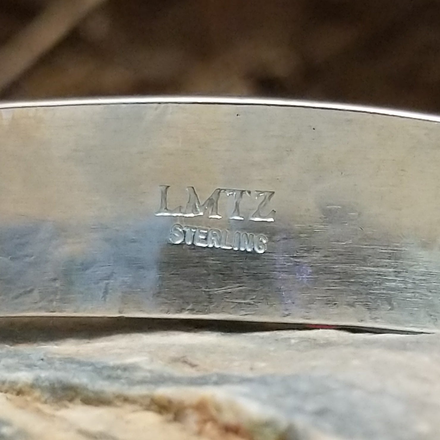 Close-up of the artisan's stamped signature.