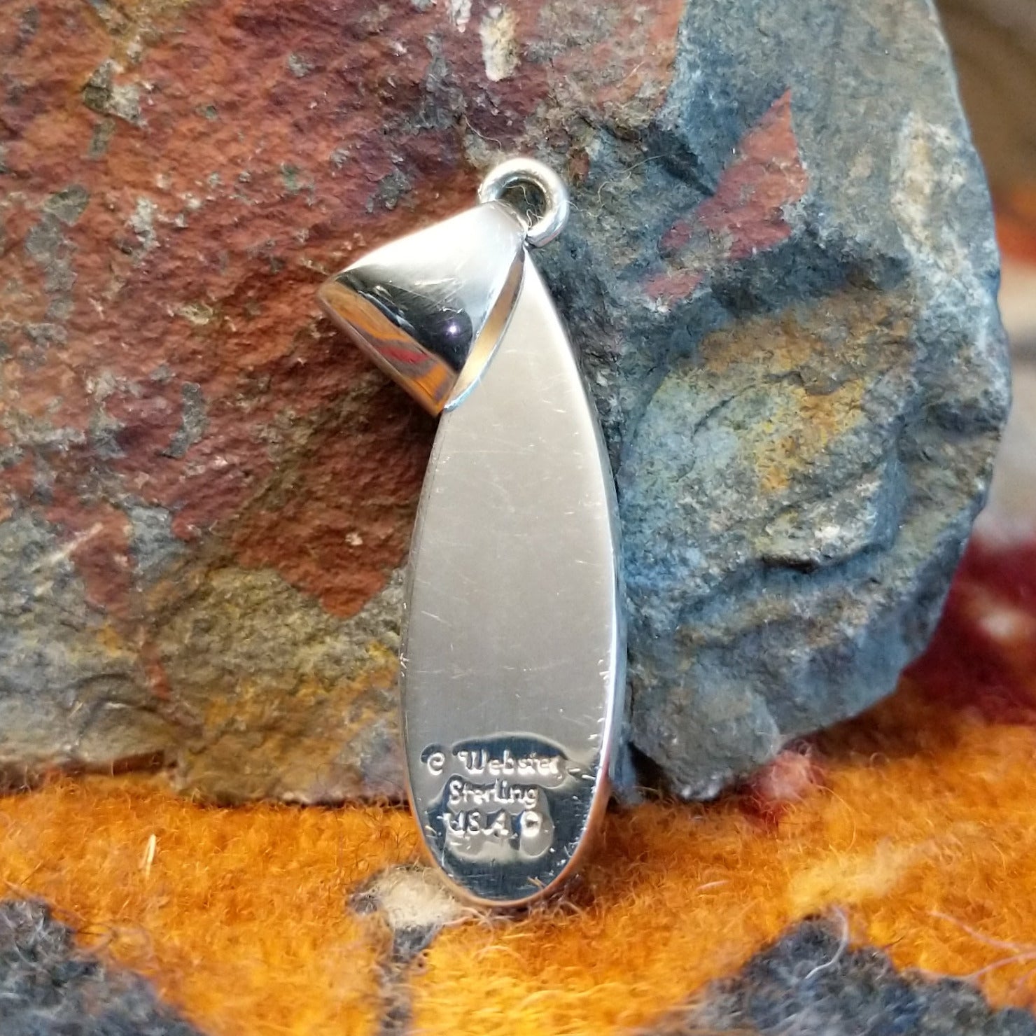 Close-up of the artisan's stamped signature.