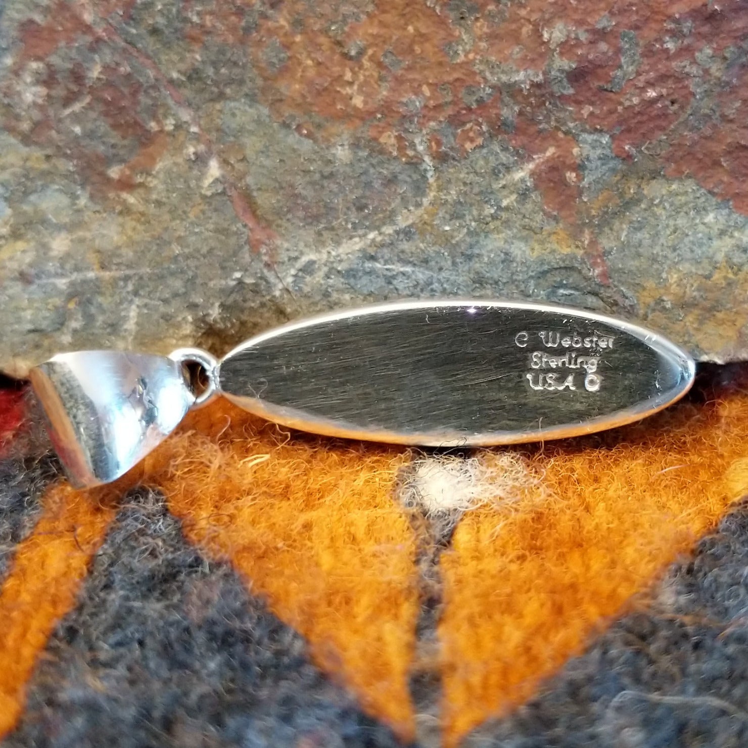 Close-up of the artisan's stamped signature.