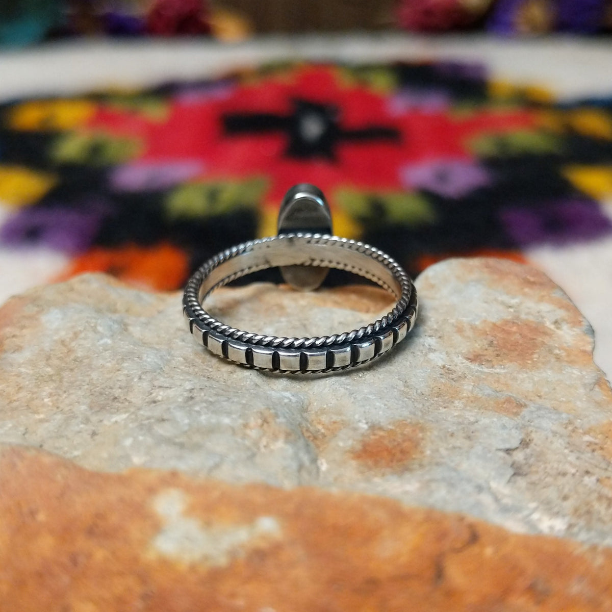Elegant Lapis Oval Ring by Elgin Tom with an elongated deep blue lapis stone set in sterling silver with twisted-rope edging and oxidized band details; underside view.