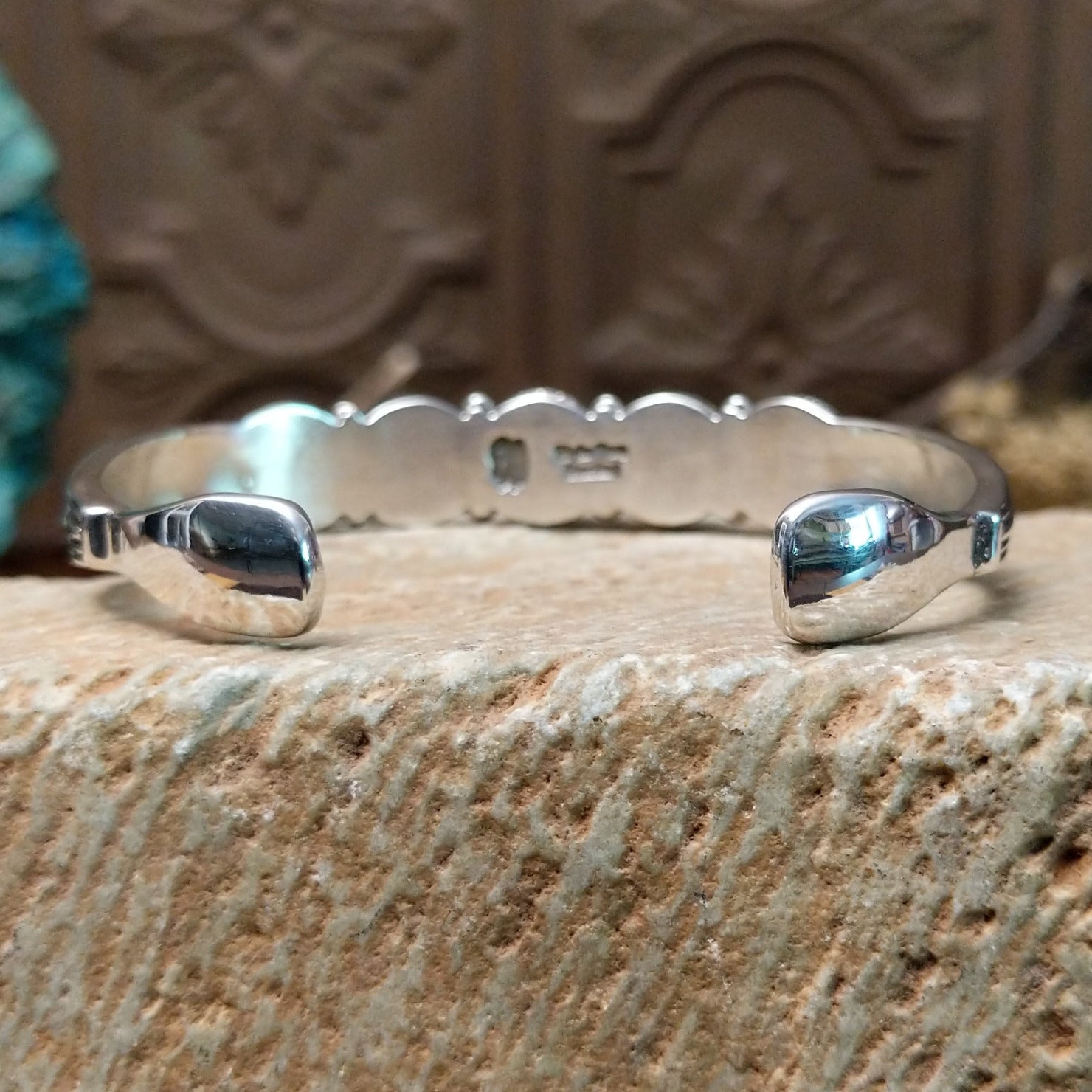 Sterling silver cuff bracelet with lapis set in a quintet of round bezels, framed by twisted rope and dotted accents.