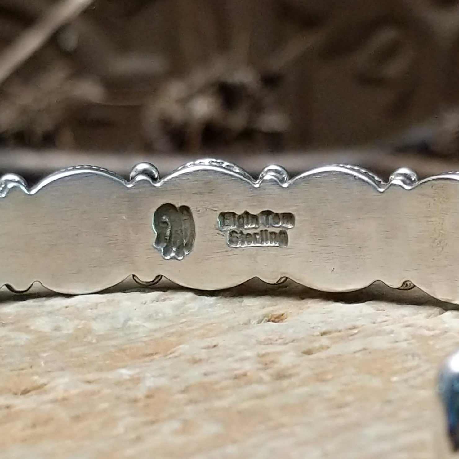 Close-up of the artisan's stamped signature.