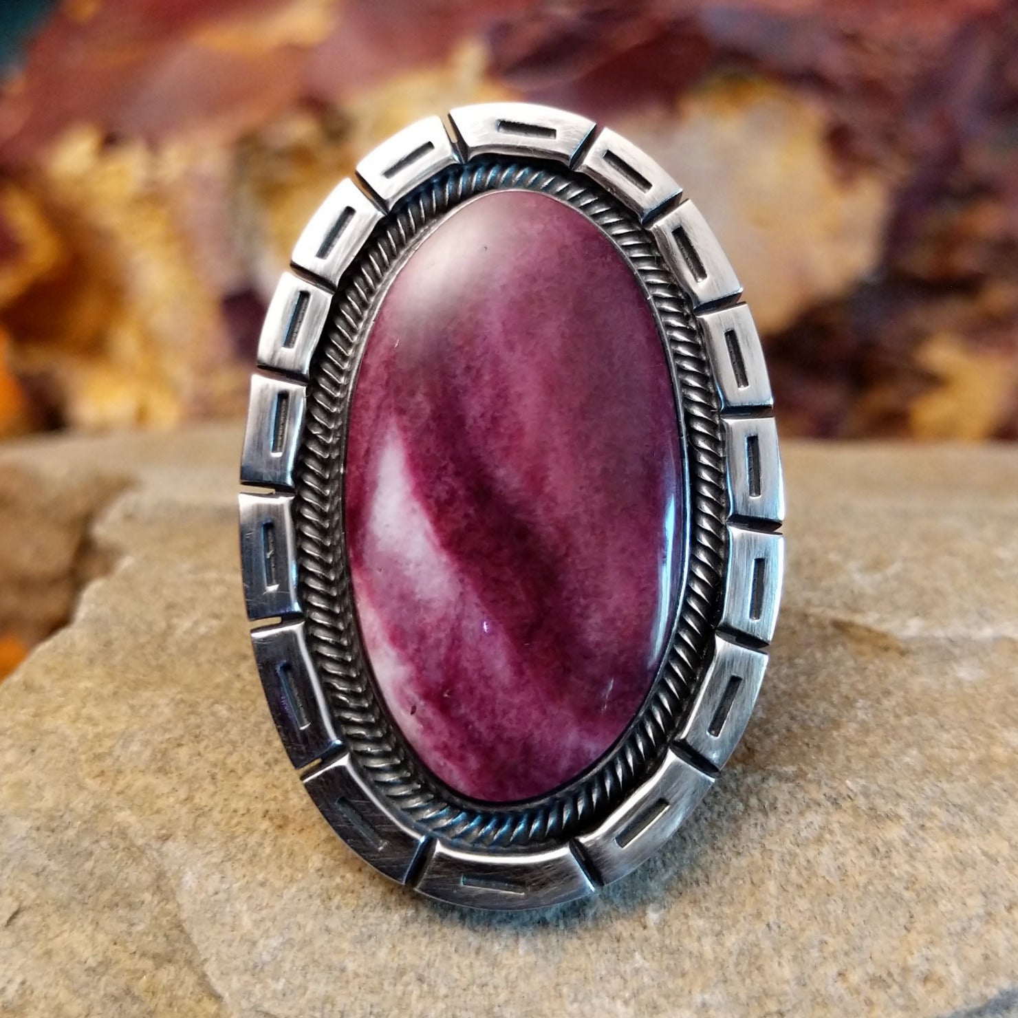 Oval purple spiny oyster shell with twisted rope bezel framed by the square inlays on the setting.