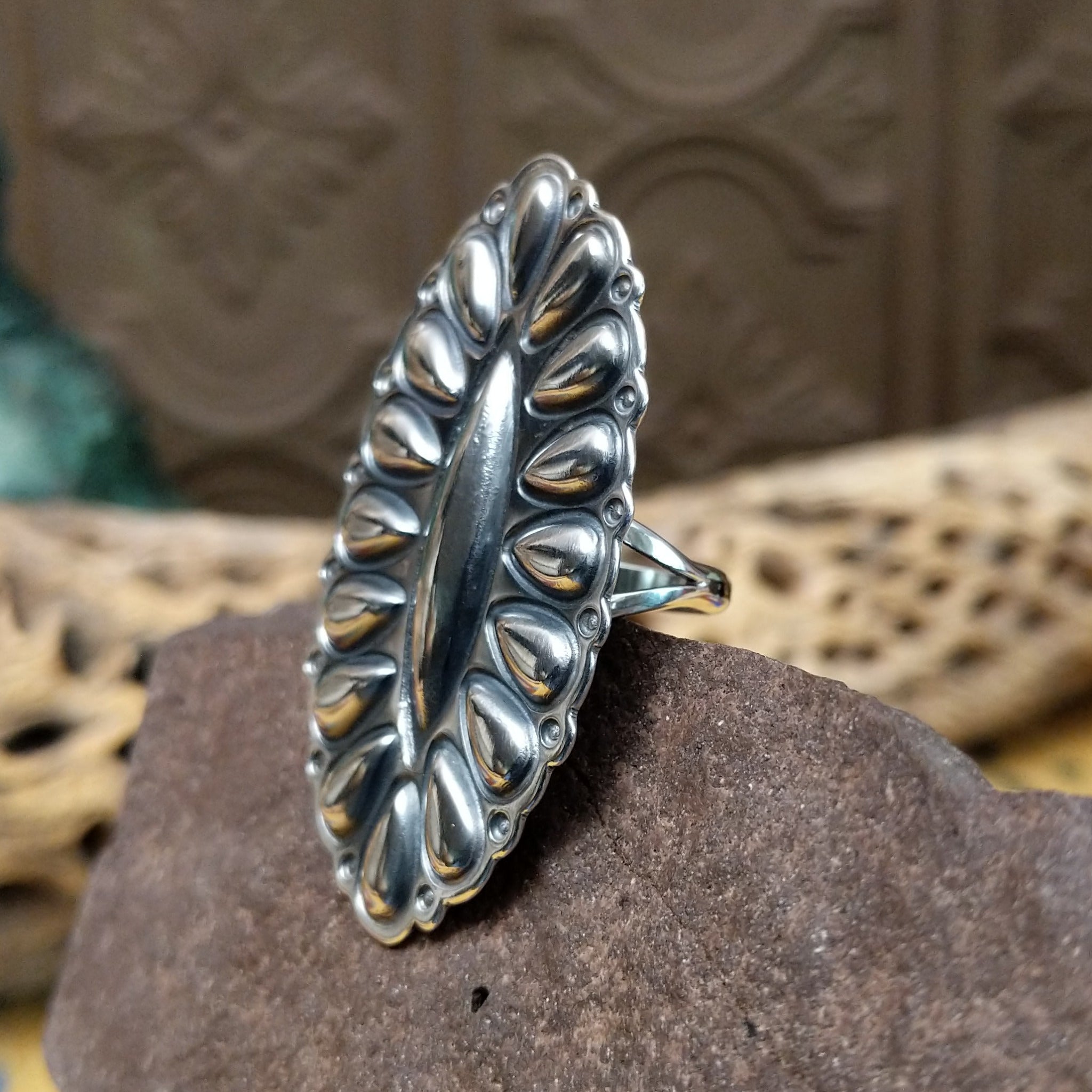 Large stamped sterling silver ring by Charles Johnson, featuring intricate hand-stamped patterns on a bold polished silver band with traditional Southwestern-inspired craftsmanship. Side view.