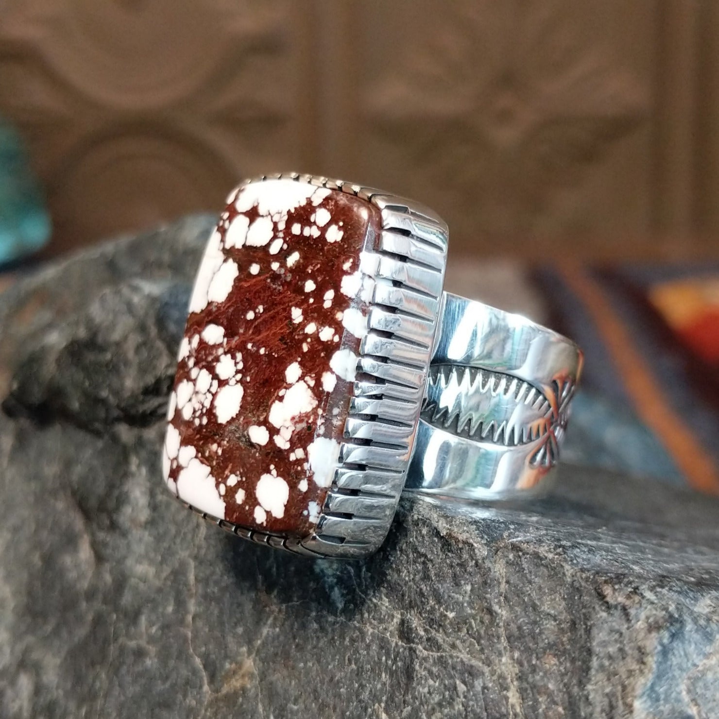 Large wild horse stone set in serrated bezel with intricately stamped band.